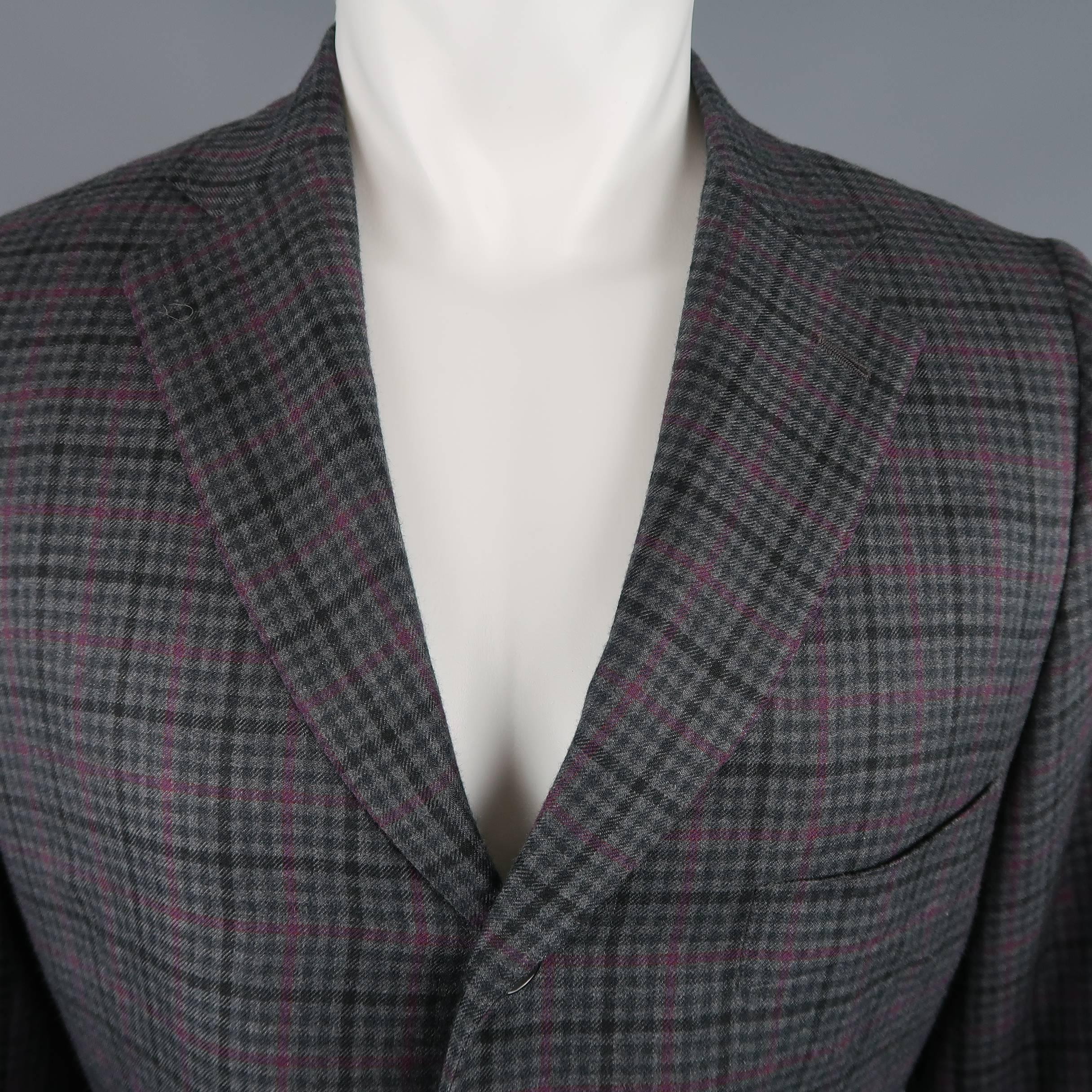 Single breasted ISAIA sport coat comes in gray cashmere with black and purple plaid print, three button front, notch lapel, and functional button cuffs. Made in Italy.
 
Excellent Pre-Owned Condition.
Marked: IT 52
 
Measurements:
 
Shoulder: 16