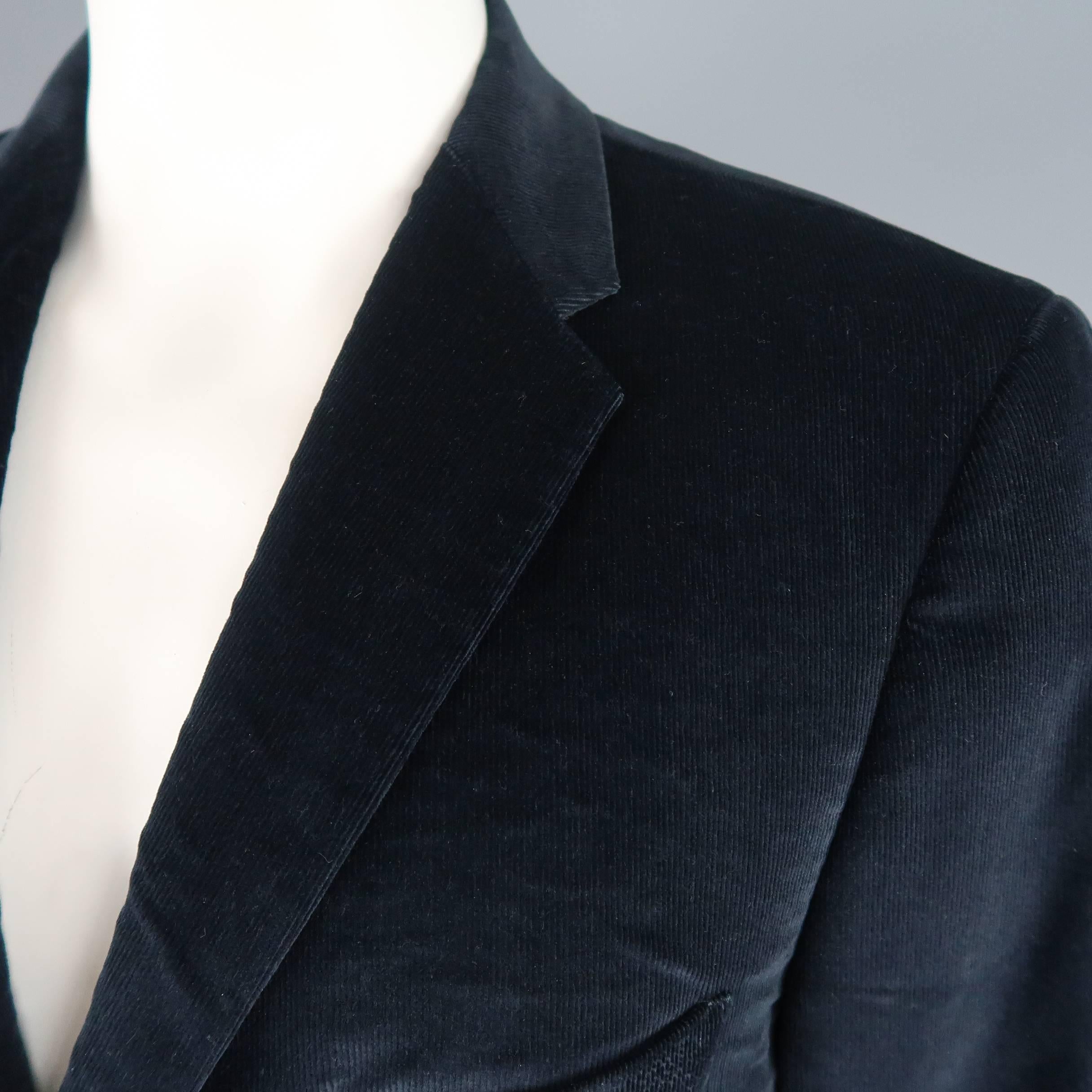 Single breasted SALVATORE FERRAGAMO sport coat comes in navy blue corduroy with a notch lapel, three button front, and floral liner. Wear throughout. As-is. Made in Italy.
 
Fair Pre-Owned Condition.
Marked: IT 56
 
Measurements:
 
Shoulder: 18
