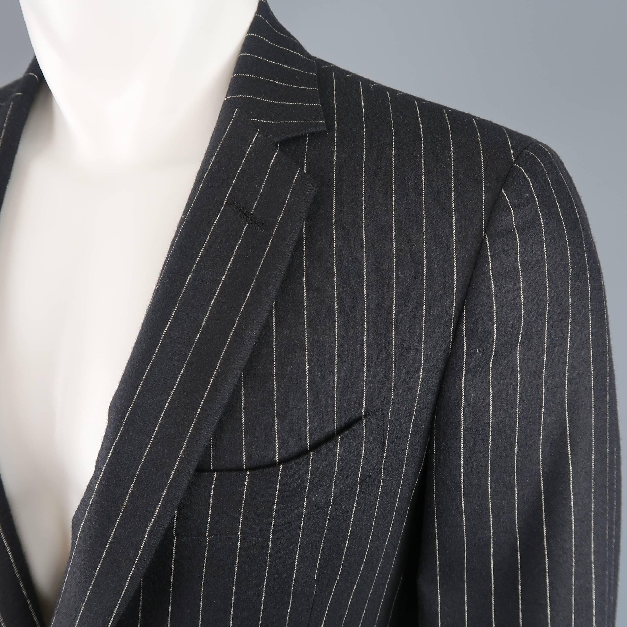 Single breasted John Varvatos sport coat comes in black wool cashmere with beige pinstripes, notch lapel, and two button front. Made in Italy.
 
Good Pre-Owned Condition.
Marked: IT 48 short
 
Measurements:
 
Shoulder: 17 in.
Chest: 40 in.
Sleeve: