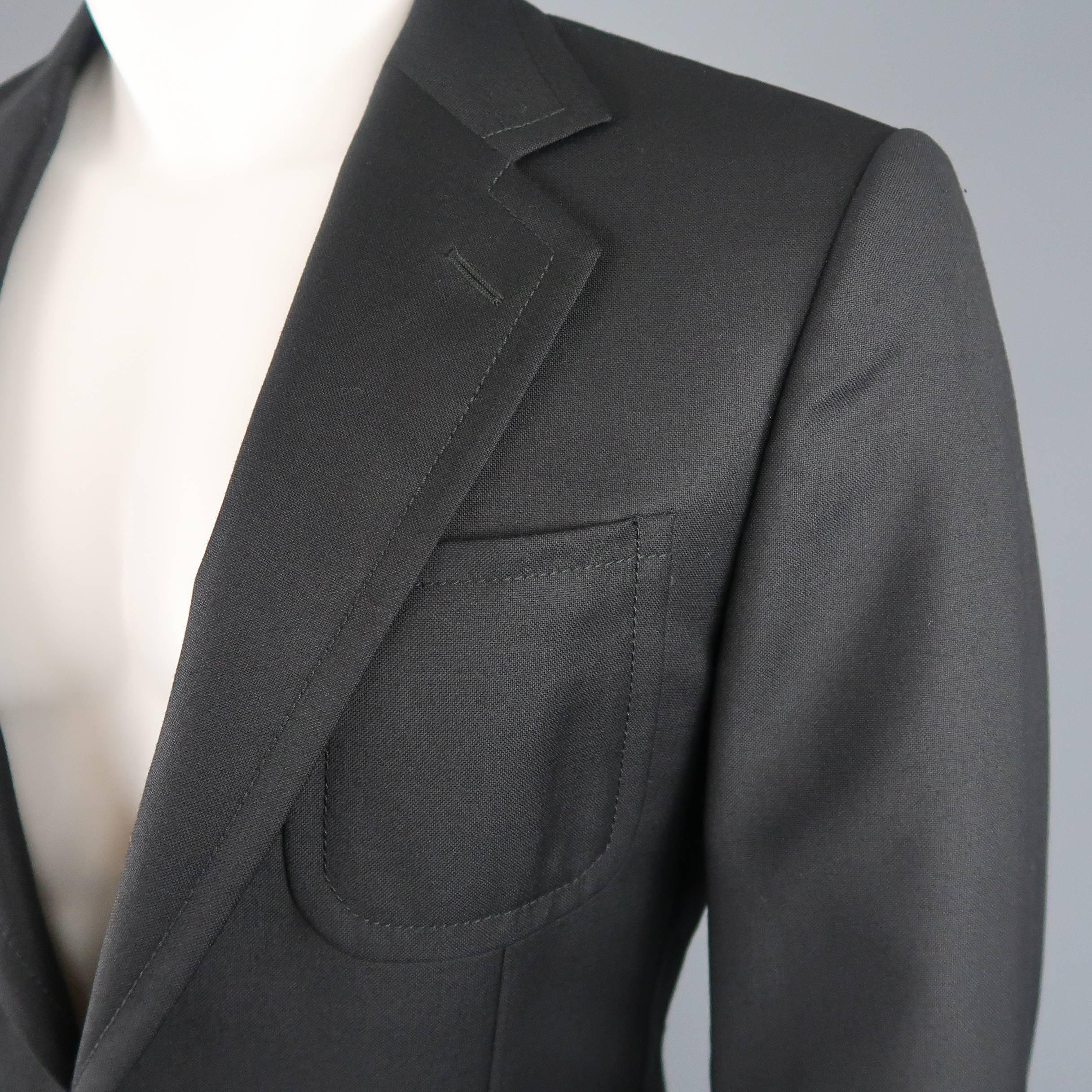 Single breasted Gucci sport coat comes in black wool with a notch lapel patch pockets, and gold tone GG buttons. Made in Switzerland.
 
New with Tags.
Marked: IT 46 R
 
Measurements:
 
Shoulder: 17 in.
Chest: 40 in.
Sleeve: 24 in.
Length: 32 in.
