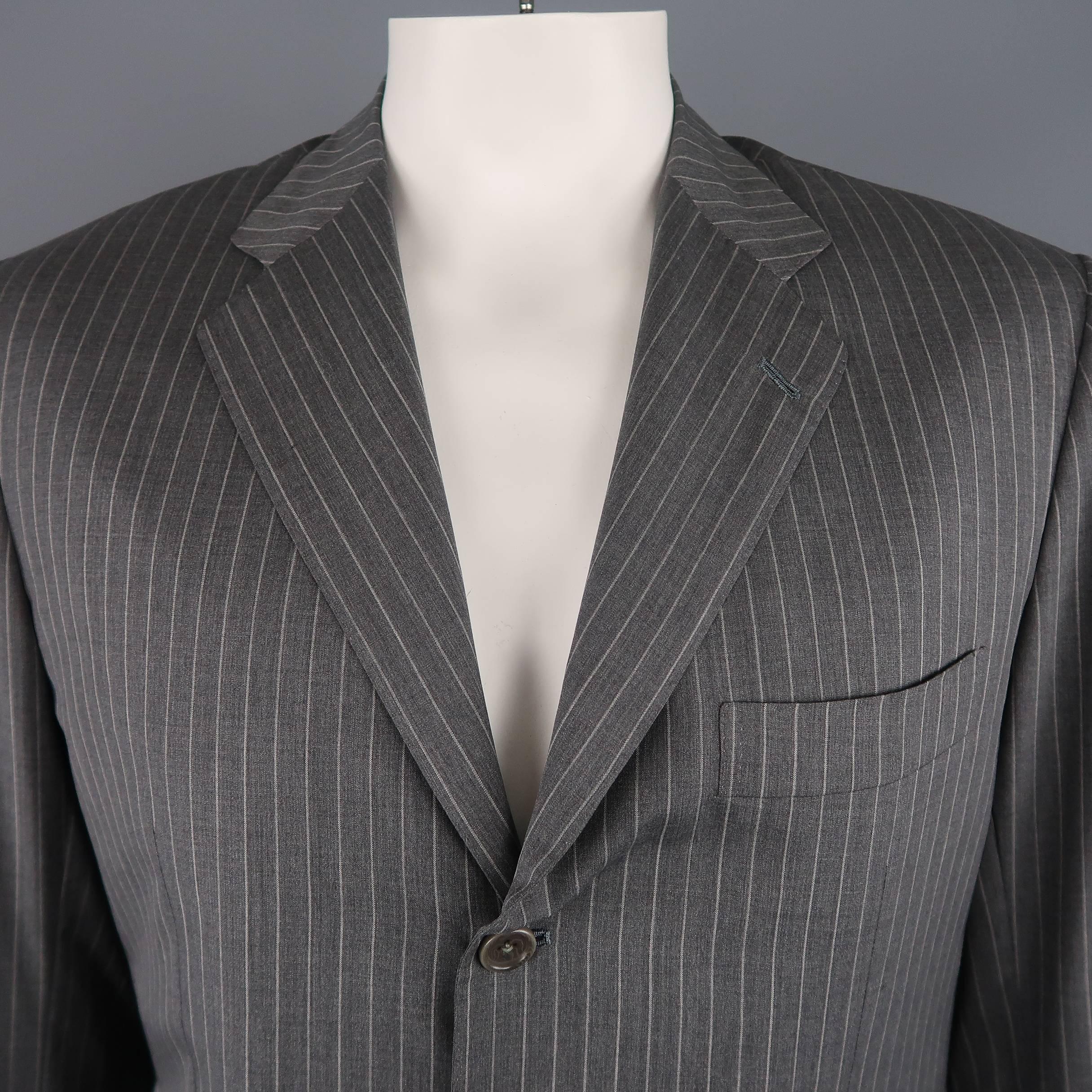 Single breasted KITON sport coat comes in stripe pattern wool with a notch lapel, flap pockets and three button closure. Made in Italy.
 
Excellent Pre-Owned Condition
Marked:42 Long
 
Measurements:
 
Shoulder: 18 in.
Sleeve: 25 in.
Chest: 42