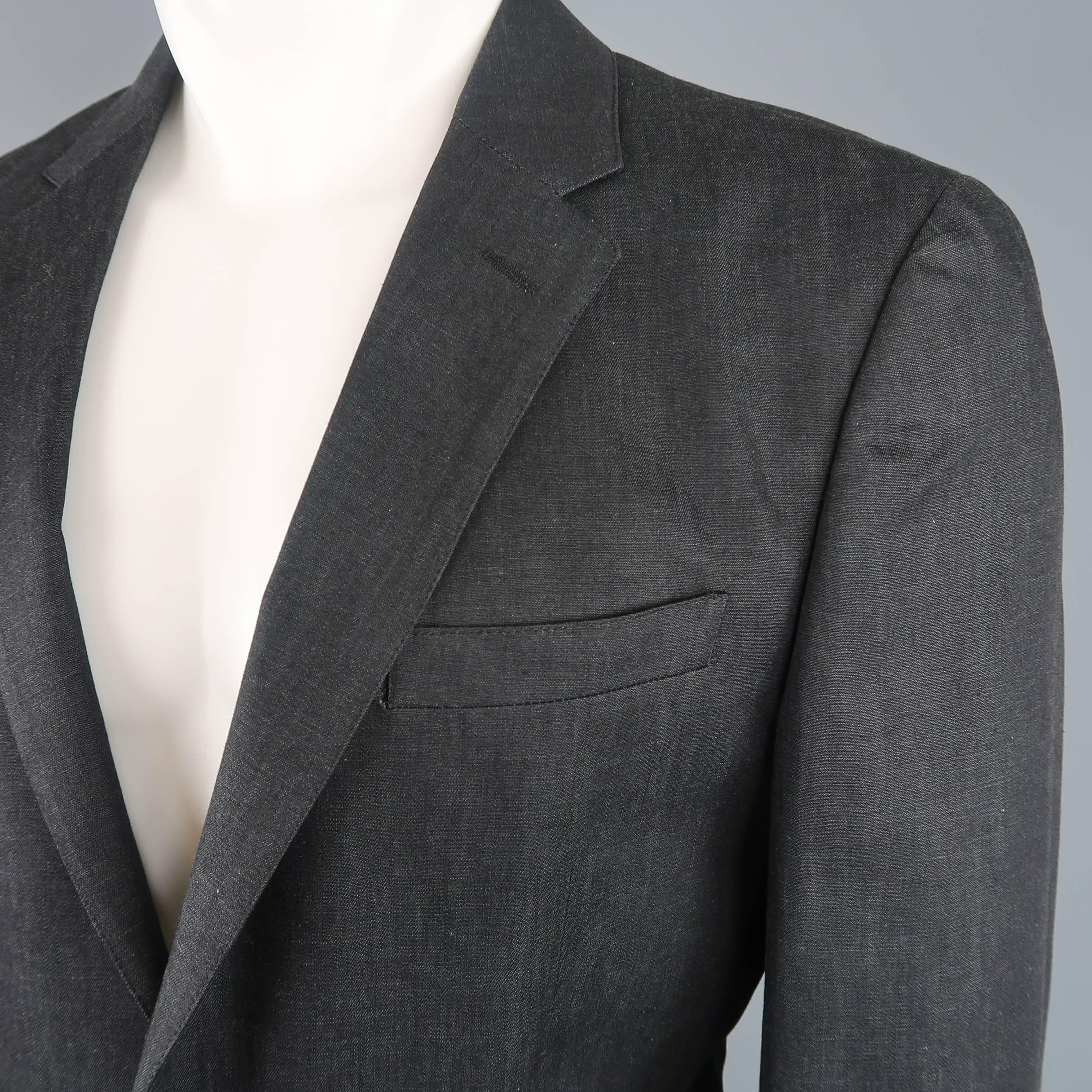 Single breasted PRADA sport coat comes in black linen textured cotton with a notch lapel, two button front, and patch pockets. Made in Italy.
 
Good Pre-Owned Condition.
Marked: IT 52
 
Measurements:
 
Shoulder: 17 in.
Chest: 42 in.
Sleeve: 26