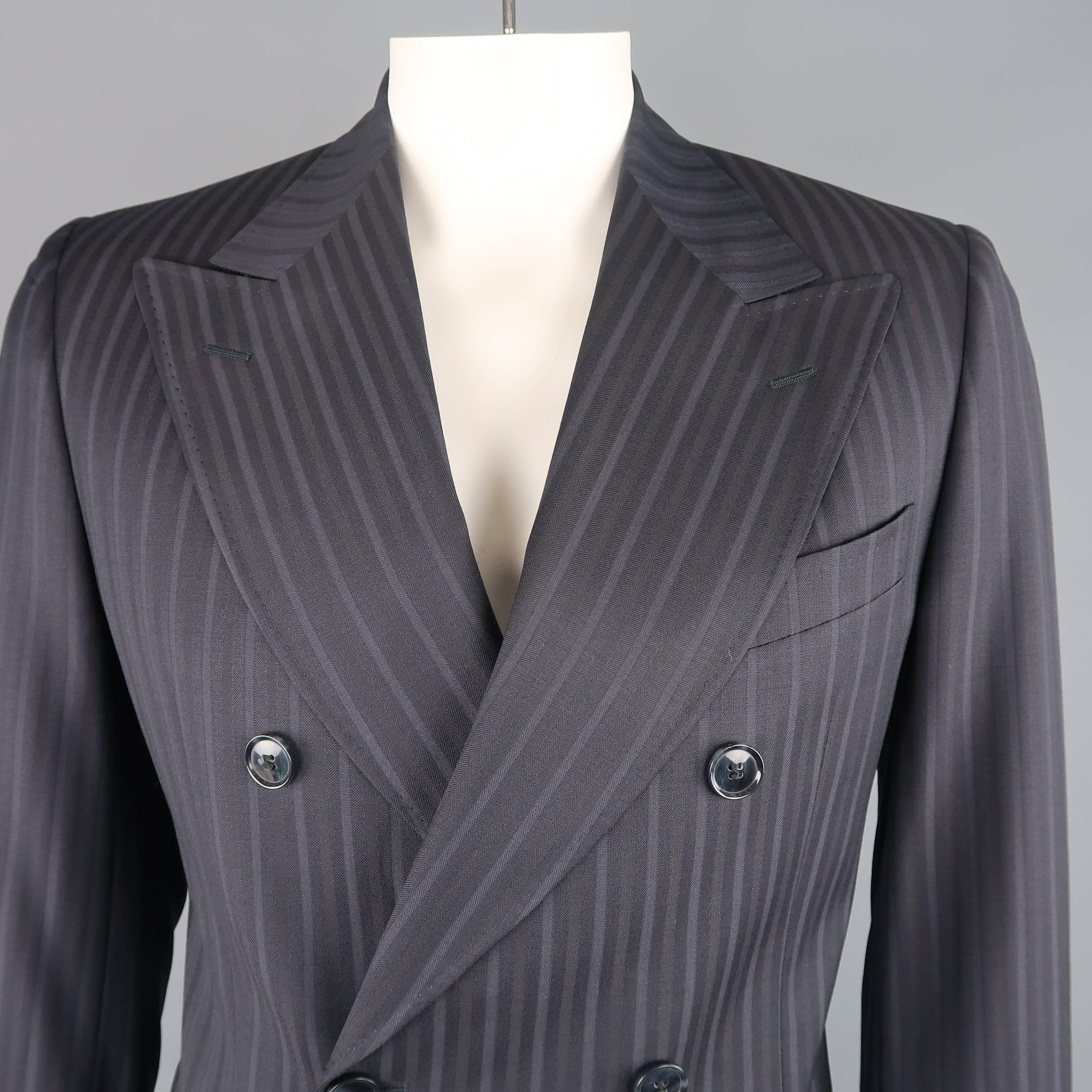 Double breasted DOLCE & GABBANA sport coat comes in navy striped wool with a wide peak lapel, two button closure, and functional button cuffs. Made in Italy.
 
Excellent Pre-Owned Condition.
Marked: IT 52
 
Measurements:
 
Shoulder: 17 in.
Chest: 44