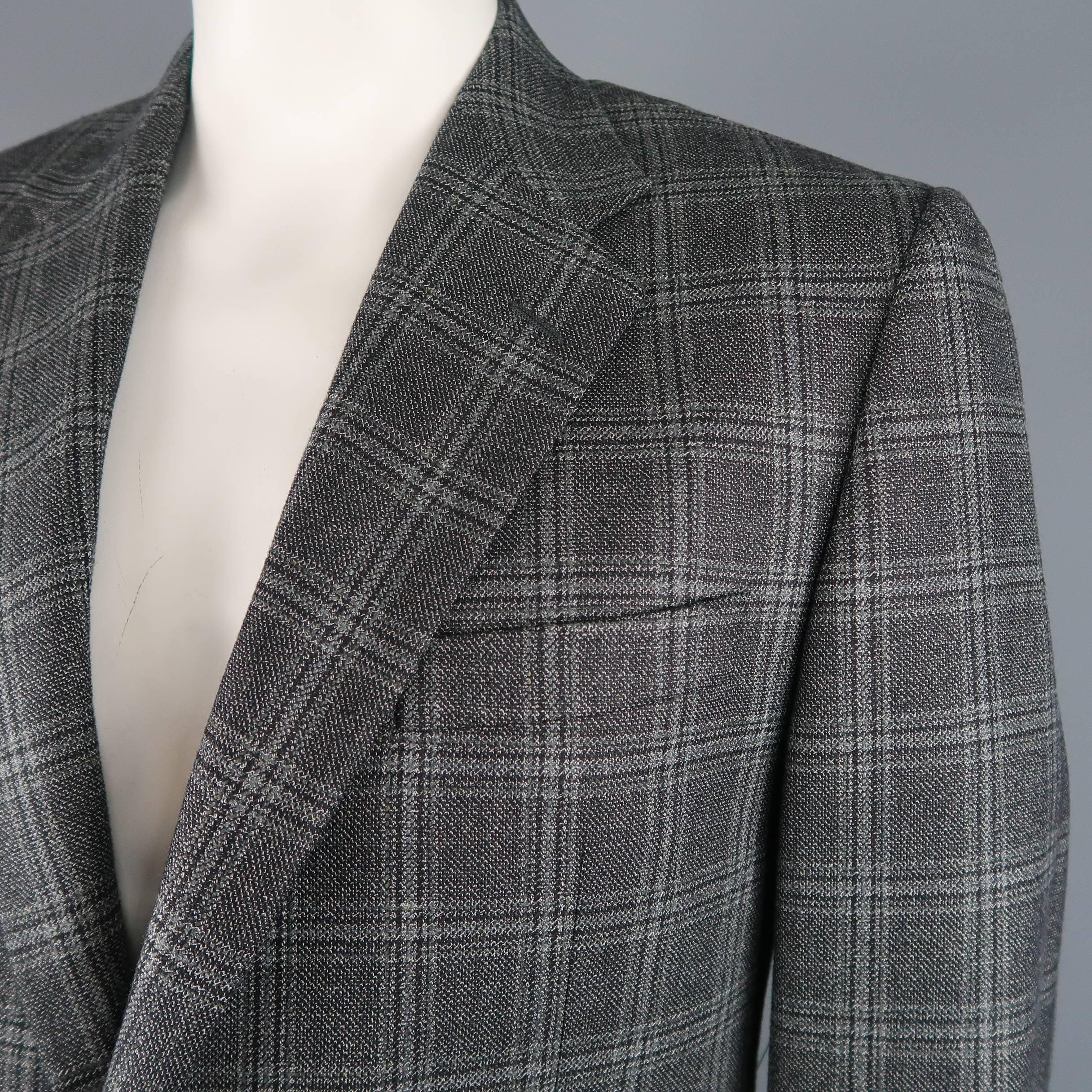 Single breasted HICKEY FREEMAN sport coat comes in dark gray plaid silk wool blend fabric with a notch lapel, two button front, and single vented back. Made in USA.
 
Excellent Pre-Owned Condition.
Marked: 42 Reg
 
Measurements:
 

    Shoulder: 18