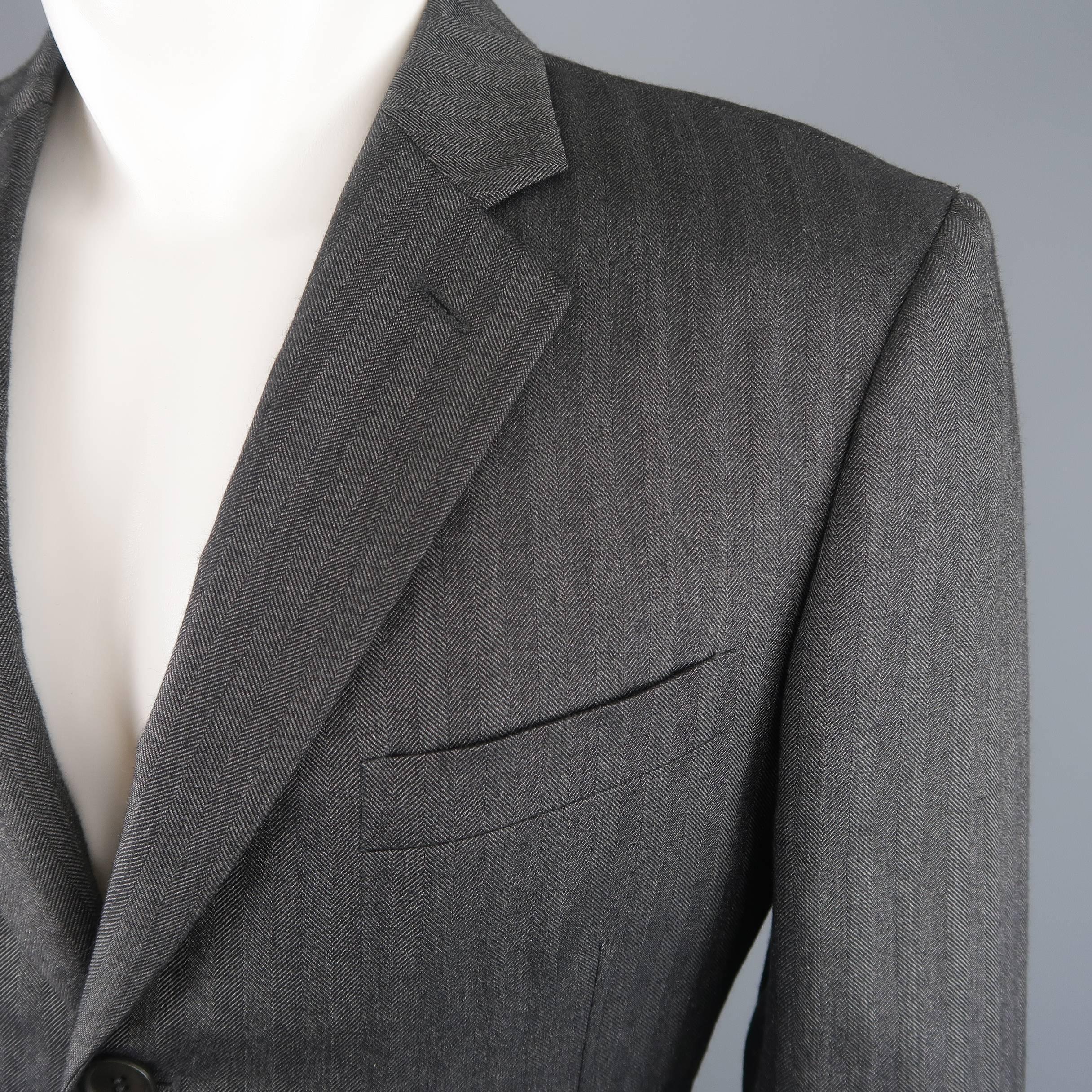 
Single breasted GIORGIO ARMANI sport coat comes in gray herringbone cashmere silk blend fabric with a notch lapel, three button front, and slit pockets. Made in Italy.
 
Excellent Pre-Owned Condition.
Marked: IT 50
 
Measurements:
 

    Shoulder:
