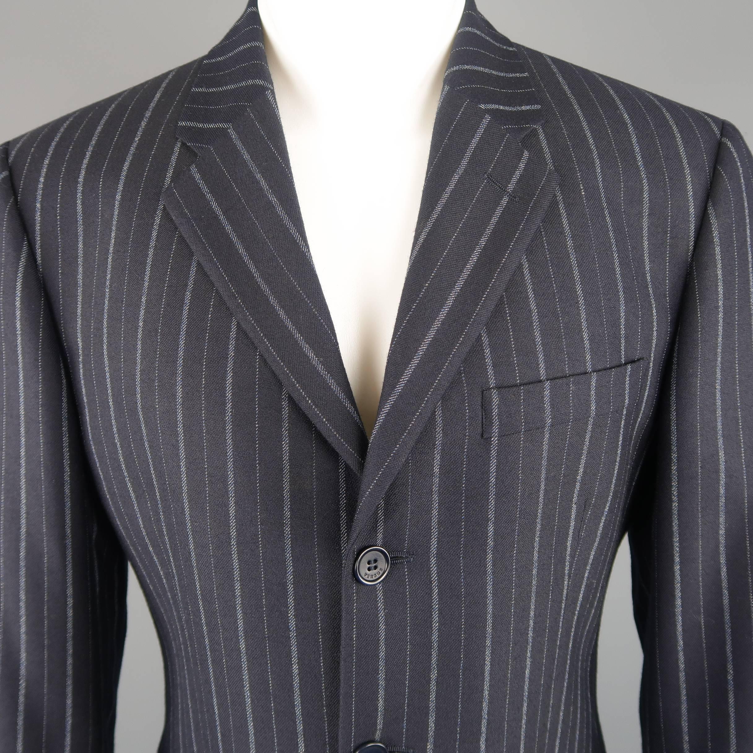 Single breasted VERSUS by GIANNI VERSACE sport coat comes in navy wool twill with pinstripe pattern, notch lapel, three button front, and double vented back. Made in Italy.
 
Excellent Pre-Owned Condition.
Marked: IT 50
 
Measurements:
 Shoulder: 18