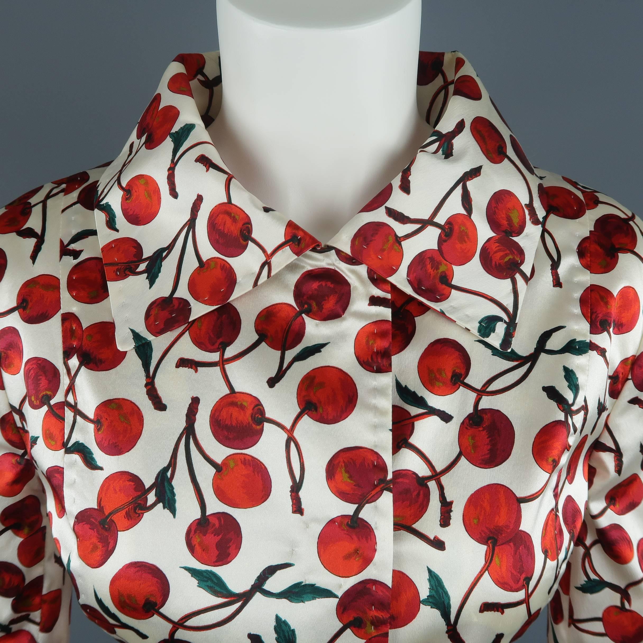 DOLCE & GABBANA jacket comes in cream and red cherry print satin with a pointed collar, cropped sleeves, and hidden placket snap closures. Made in Italy.
 
Excellent Pre-Owned Condition.
Marked: (no size)
 
Measurements:
 
Shoulder: 15 in.
Bust: 36
