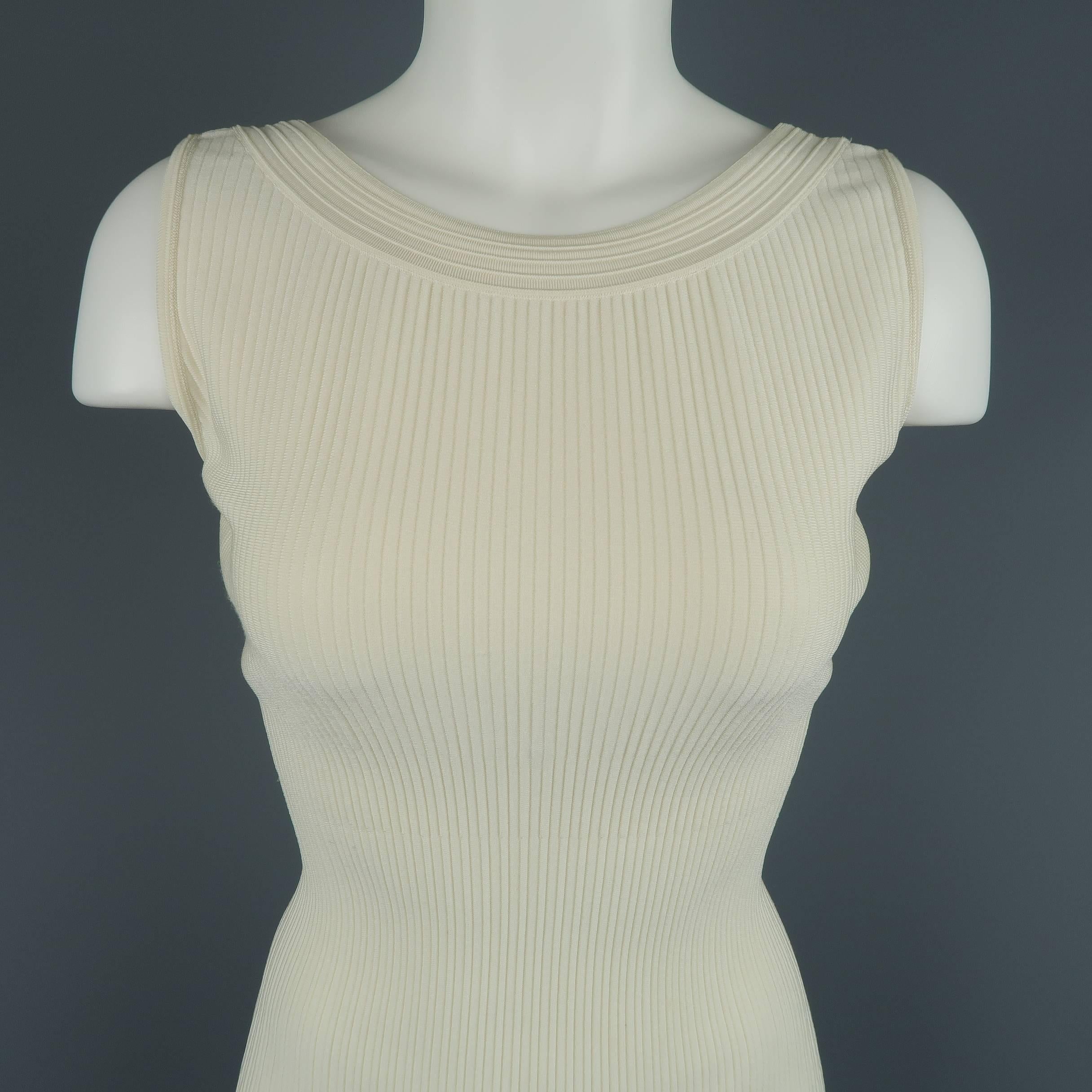 ALAIA bodycon dress comes in creamy beige ribbed stretch knit with a scoop neck and deep V back. Made in Italy.
 
Excellent Pre-Owned Condition.
Marked: XS
 
Measurements:
 
Shoulder: 12.5 in.
Bust: 36 in.
Waist: 22 in.
Hip: 26 in.
Length: 39 in.