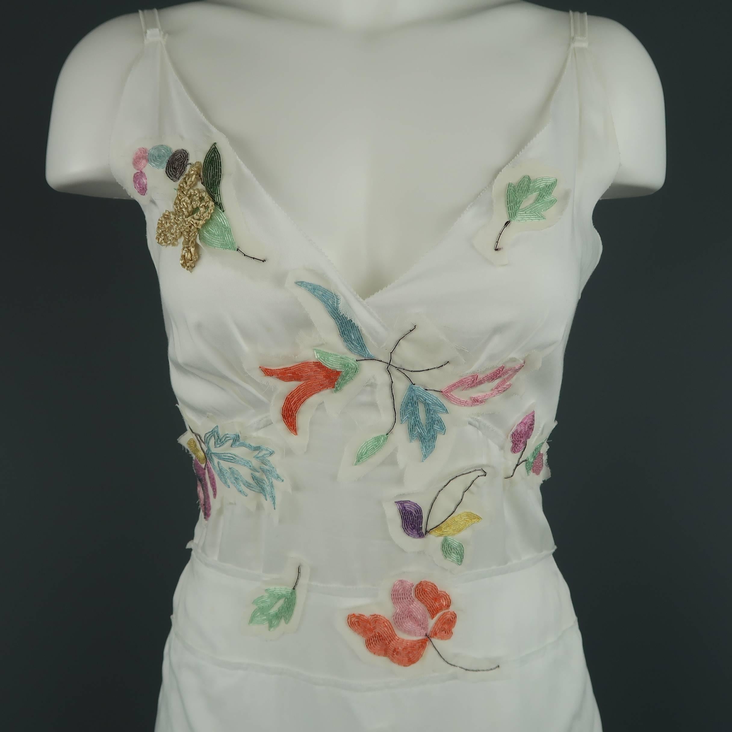 PRADA sun dress comes in white cotton muslin with spaghetti straps, camisole top, layered A line skirt with tied back, and multi color beaded leaf patches. Made in Italy.
 
Excellent Pre-Owned Condition.
Marked: IT 42
 
Measurements:
 
Shoulder: 14
