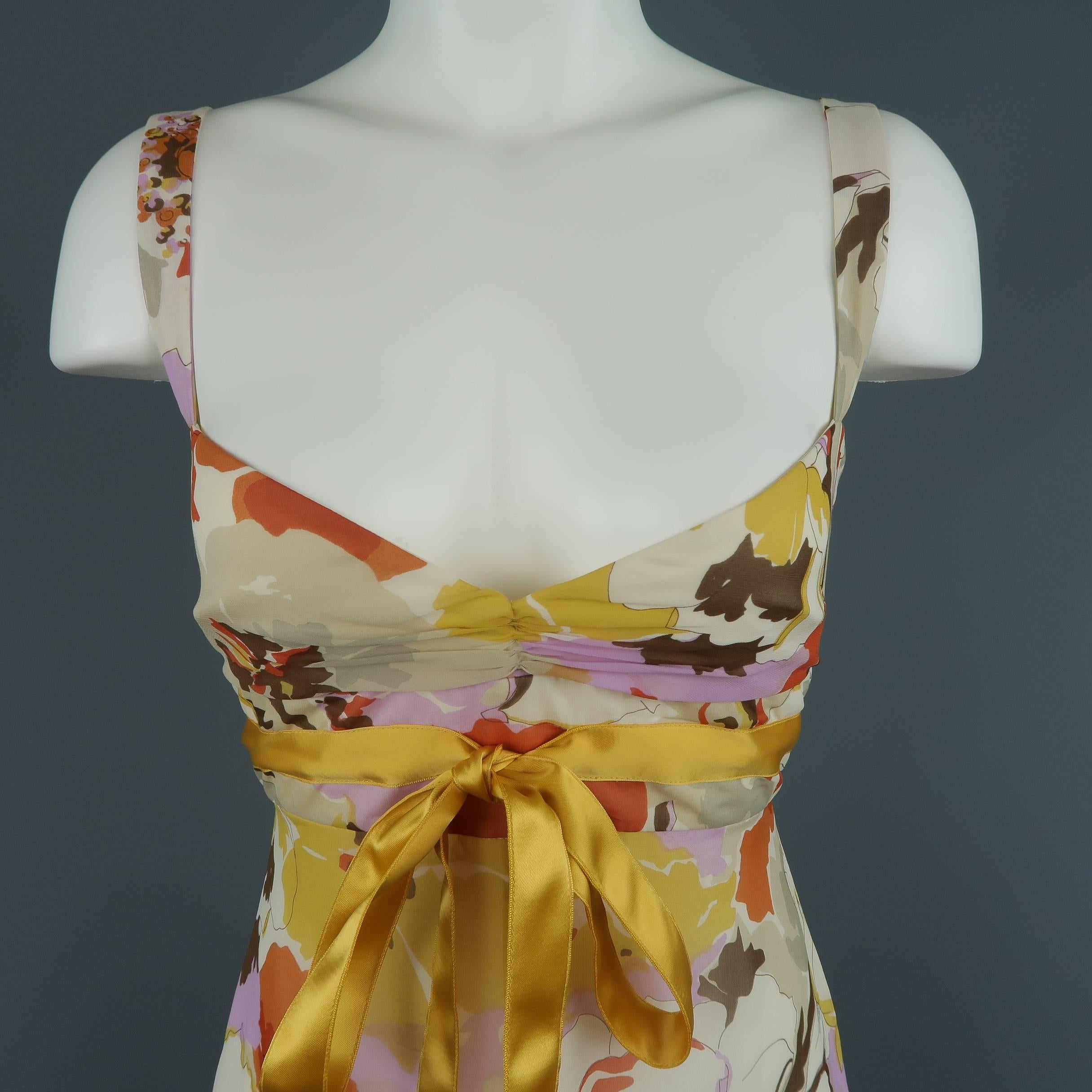 VALENTINO babydoll dress comes in orange purple and beige floral print silk chiffon with a gathered bust, empire waist with yellow satin bow, and A line skirt. Made in Italy.
 
Good Pre-Owned Condition.
Marked: (no size)
 
Measurements:
 
Bust: 34