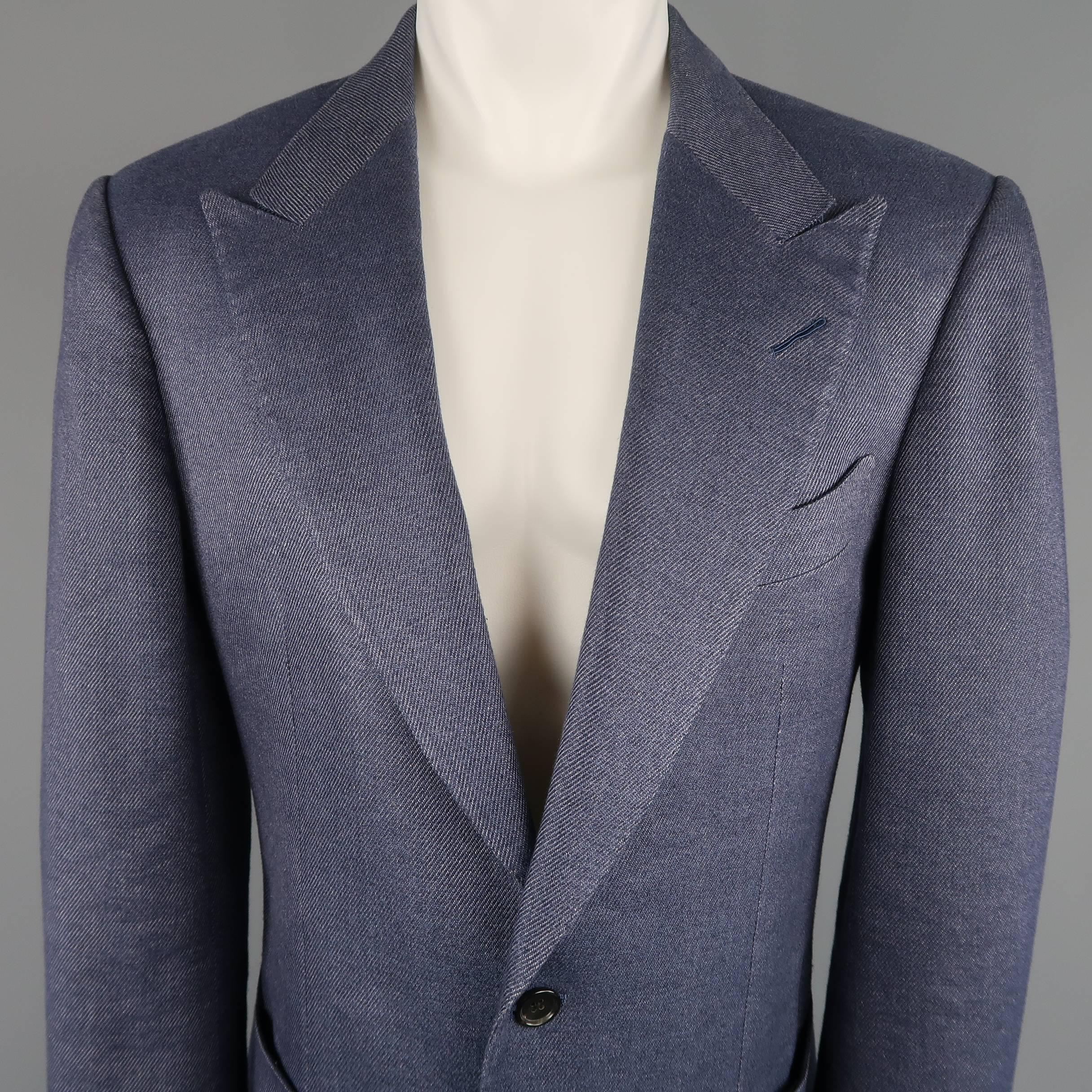 Single breasted Tom Ford sport coat comes in a light navy blue linen silk blend stripe textured material with a wide peak lapel, two button front, patch pockets and functional button cuffs. Minor wear. Made in Italy.
 
Good Pre-Owned