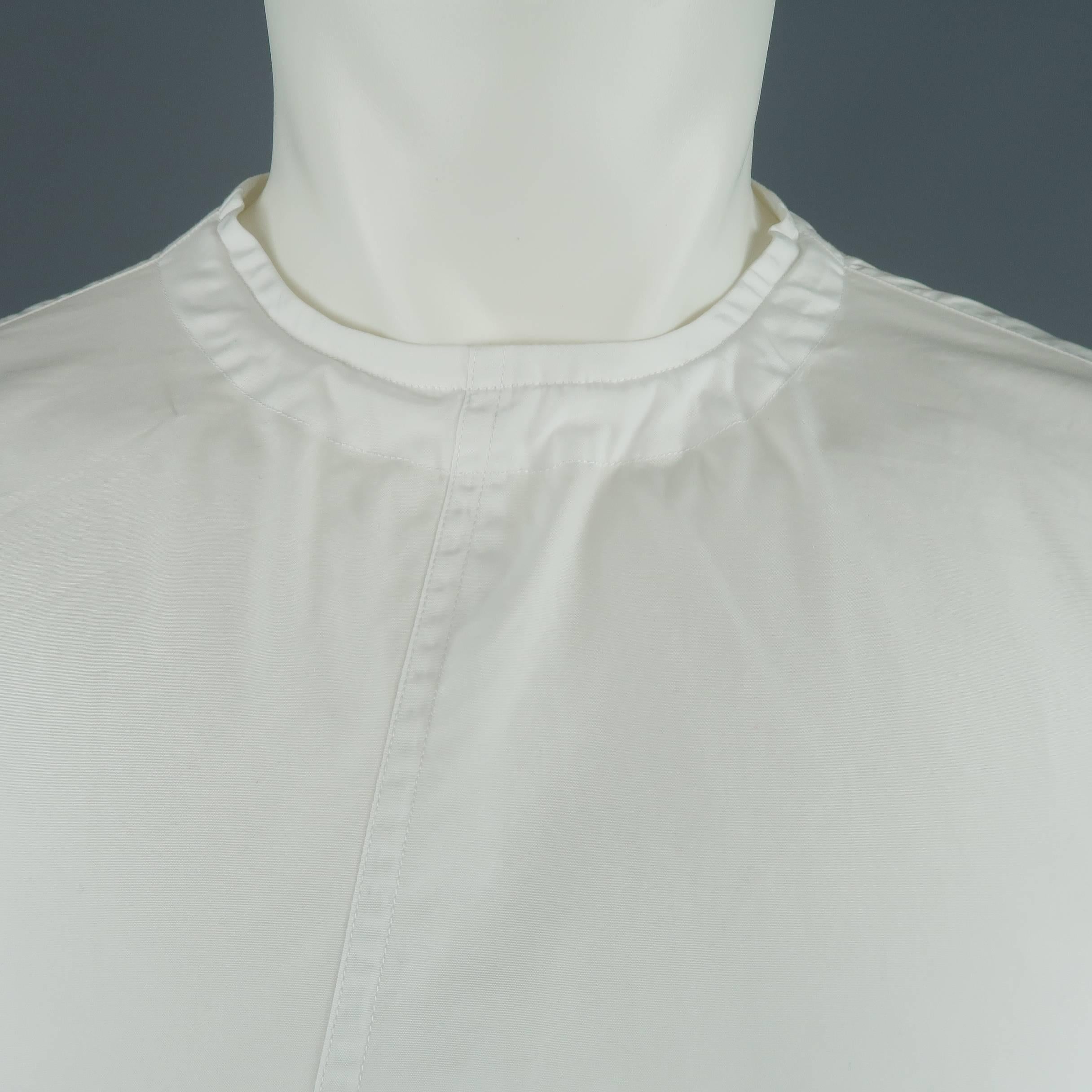 MARNI oversized tunic shirt comes in white cotton with a round neck asymmetrical frontal seam, raw hem, and back button up closure with tie. Made in Italy.
 
New with Tags.
Marked: IT 48
 
Measurements:
 
Shoulder: 21 in.
Chest: 50 in.
Sleeve: 24