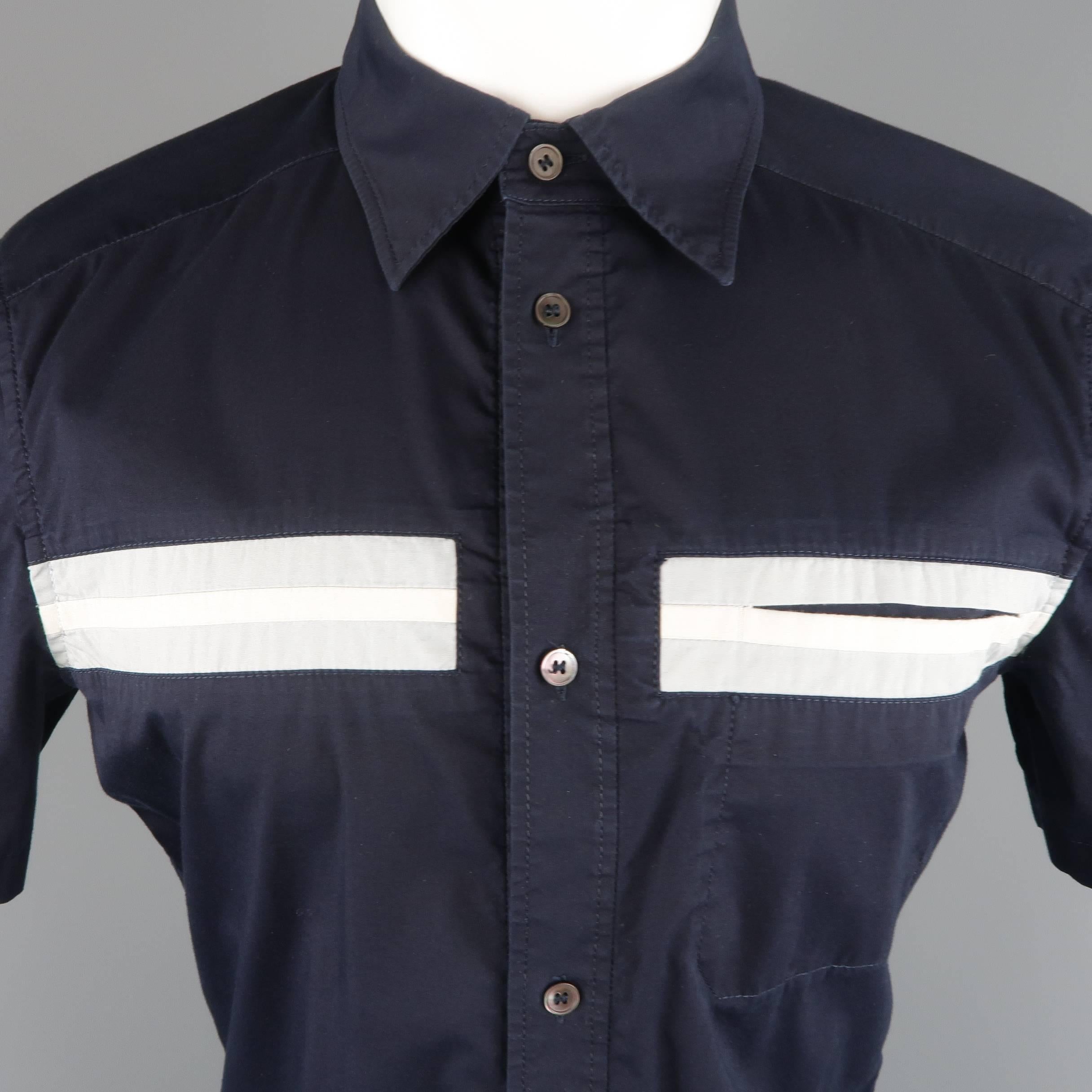 PRADA short sleeve shirt comes in navy stretch cotton with a pointed collar, light blue and white stripe, pocket, and red rubber logo tab. Made in Italy.
 
Good Pre-Owned Condition.
Marked: M
 
Measurements:
 
Shoulder: 16 in.
Chest: 41 in.
Sleeve: