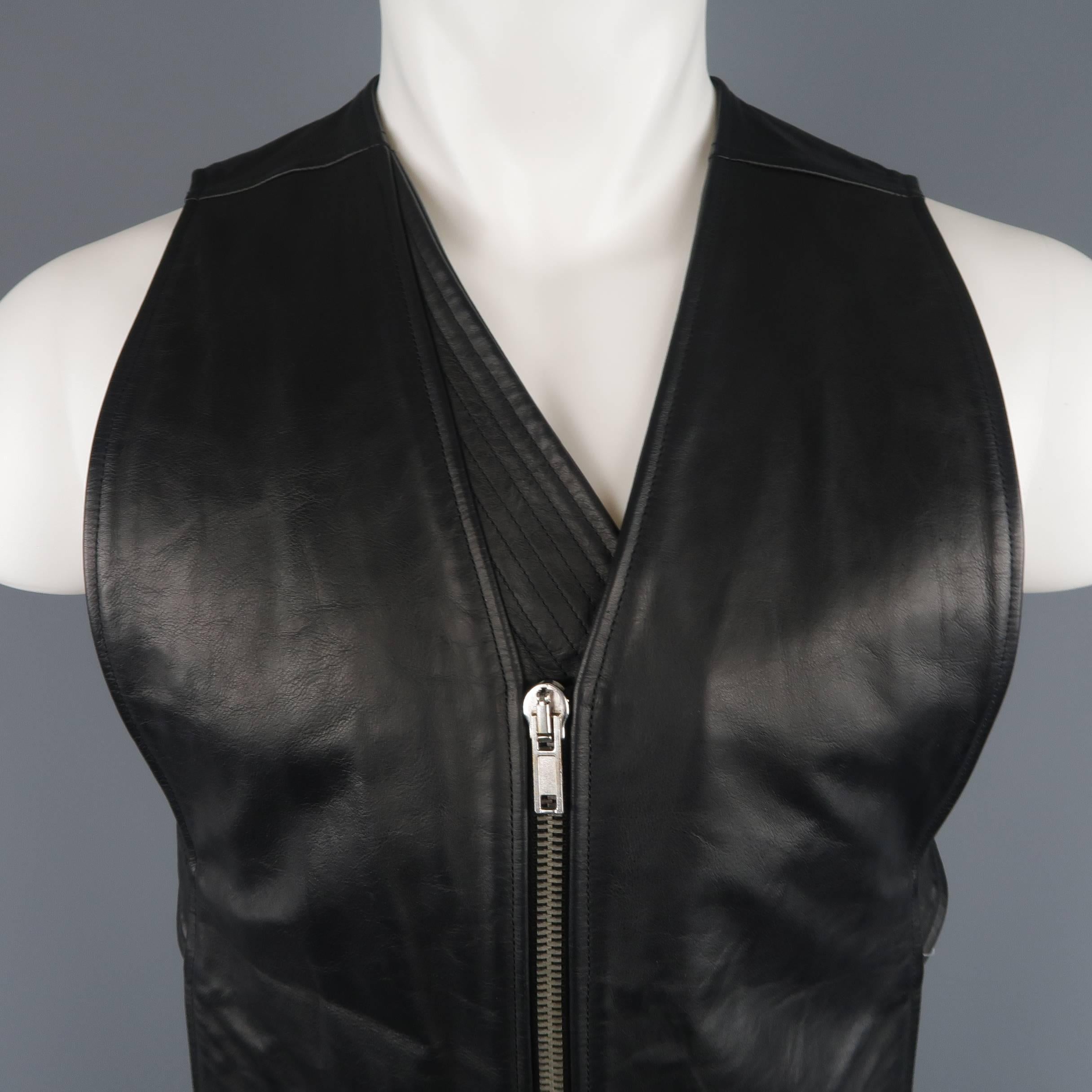 RICK OWENS vest comes in black leather with a zip front, inverted V hem, and open back with cream fabric sash. Made in Italy.
 
Good Pre-Owned Condition.
Marked: S
 
Measurements:
 
Shoulder: 12.5 in.
Chest: 36 in.
Length: 40 in.