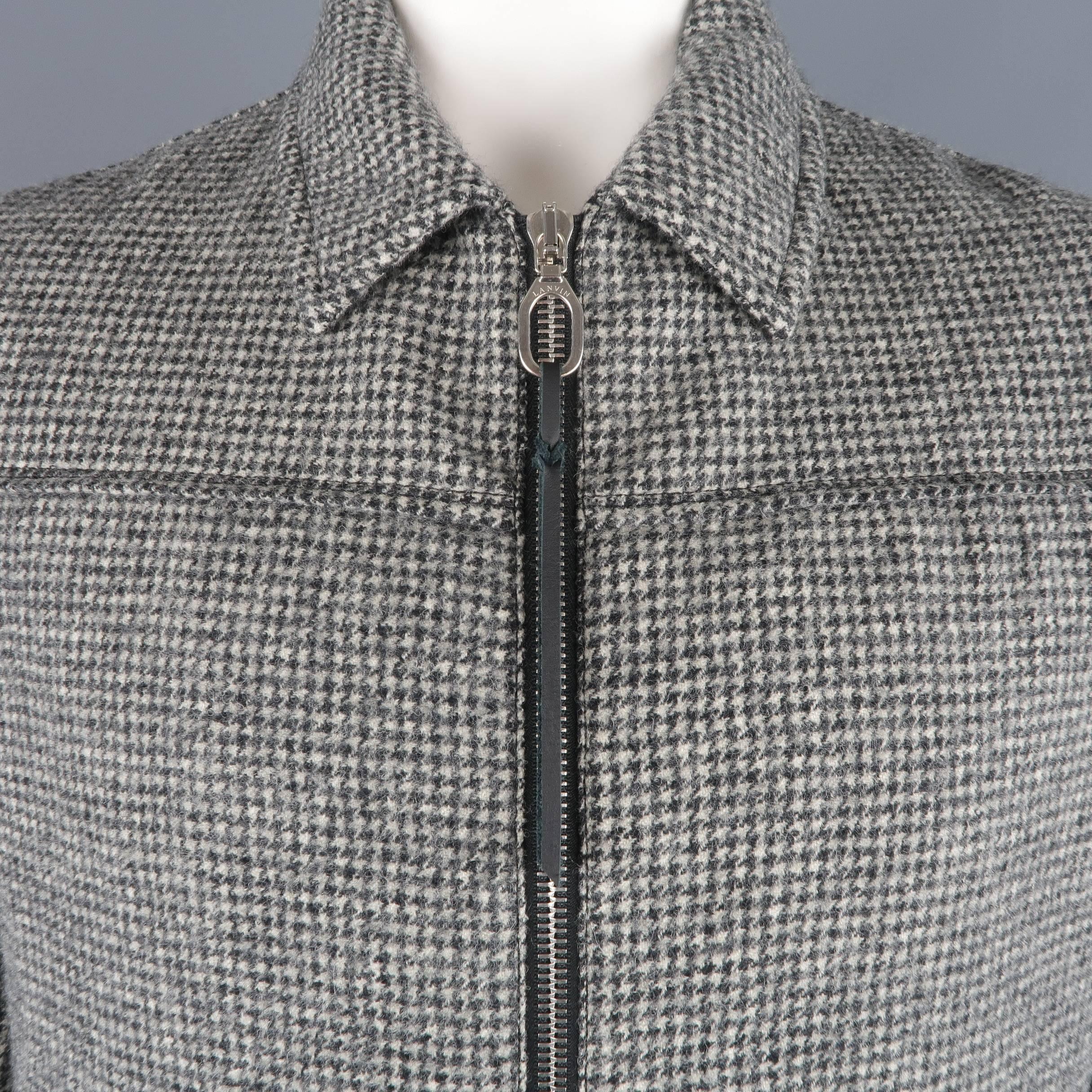 LANVIN blouson jacket comes in beige and black houndstooth wool with a pointed collar, zip front with loop and leather tab, and slanted zip pockets. Made in Romania.
 
Excellent Pre-Owned Condition.
Marked: IT 54
 
Measurements:
 
Shoulder: 20