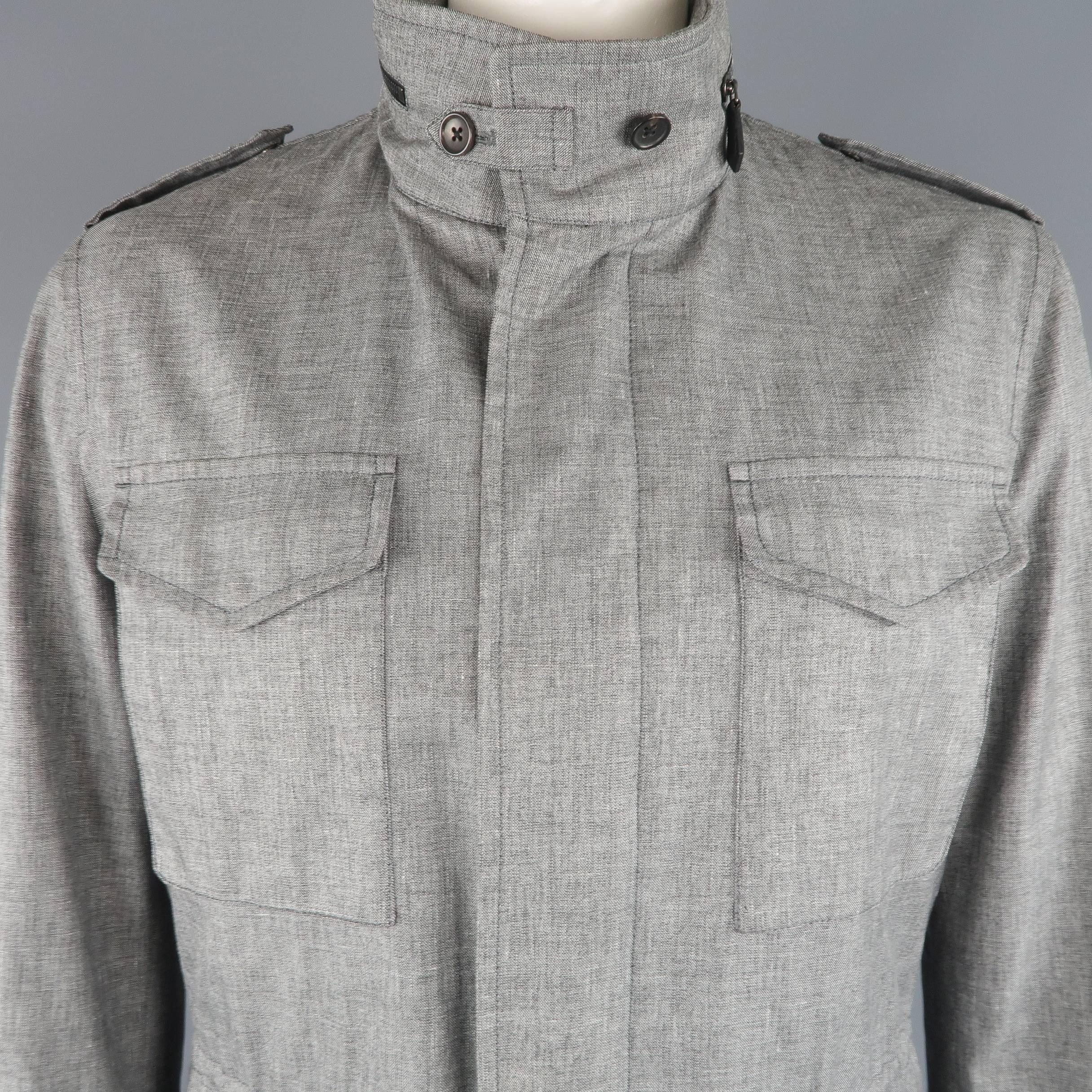 TOM FORD parka comes in linen blend light heather gray fabric with a high collar, epaulets, hidden placket zip closure, drawstring waist, zip out hood, and patch flap pockets. Minor wear. Made in Italy.
 
Good Pre-Owned Condition.
Marked: IT 56
