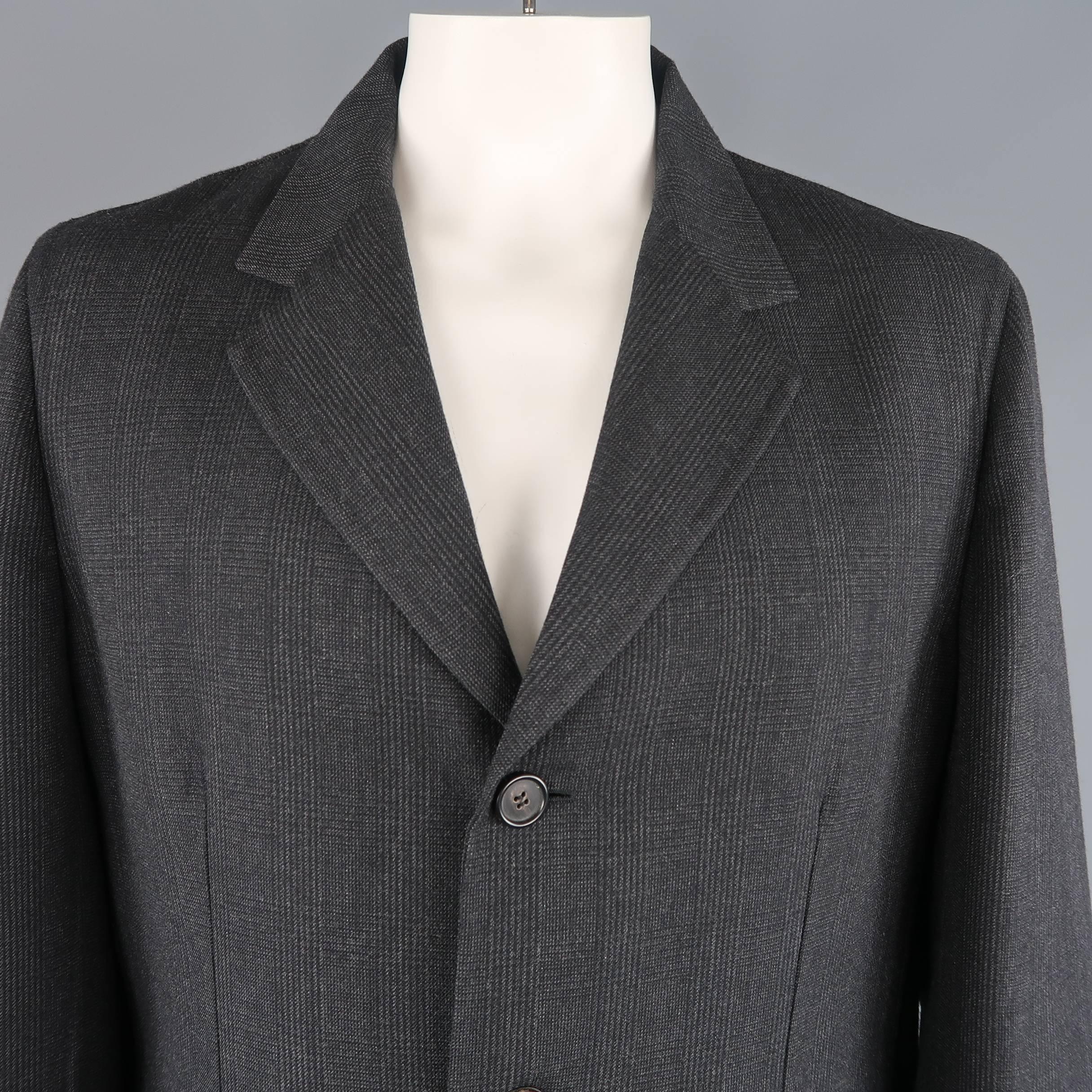 PRADA overcoat comes in charcoal gray glenplaid print structured wool with a notch lapel, three button front, and flap pockets. Made in Italy.
 
Excellent Pre-Owned Condition.
Marked: IT 56
 
Measurements:
 
Shoulder: 19 in.
Chest: 48 in.
Sleeve: 26