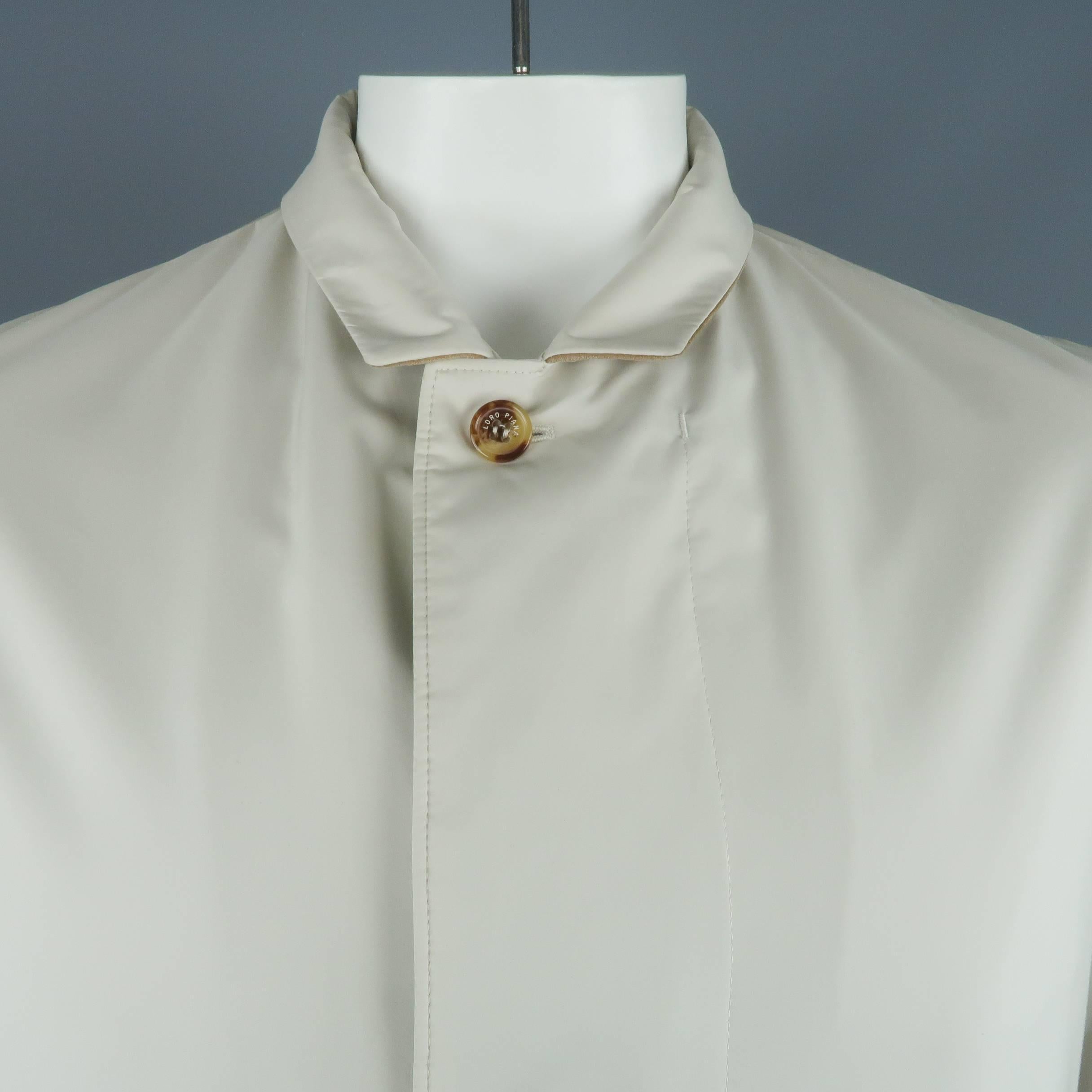 LORO PIANA car coat comes in khaki fabric with a small collar lined in tan suede, double zip front with buttoned placket, slanted pockets, and cashmere liner. Made in Italy.
 
Good Pre-Owned Condition.
Marked: M
 
Measurements:
 
Shoulder: 18