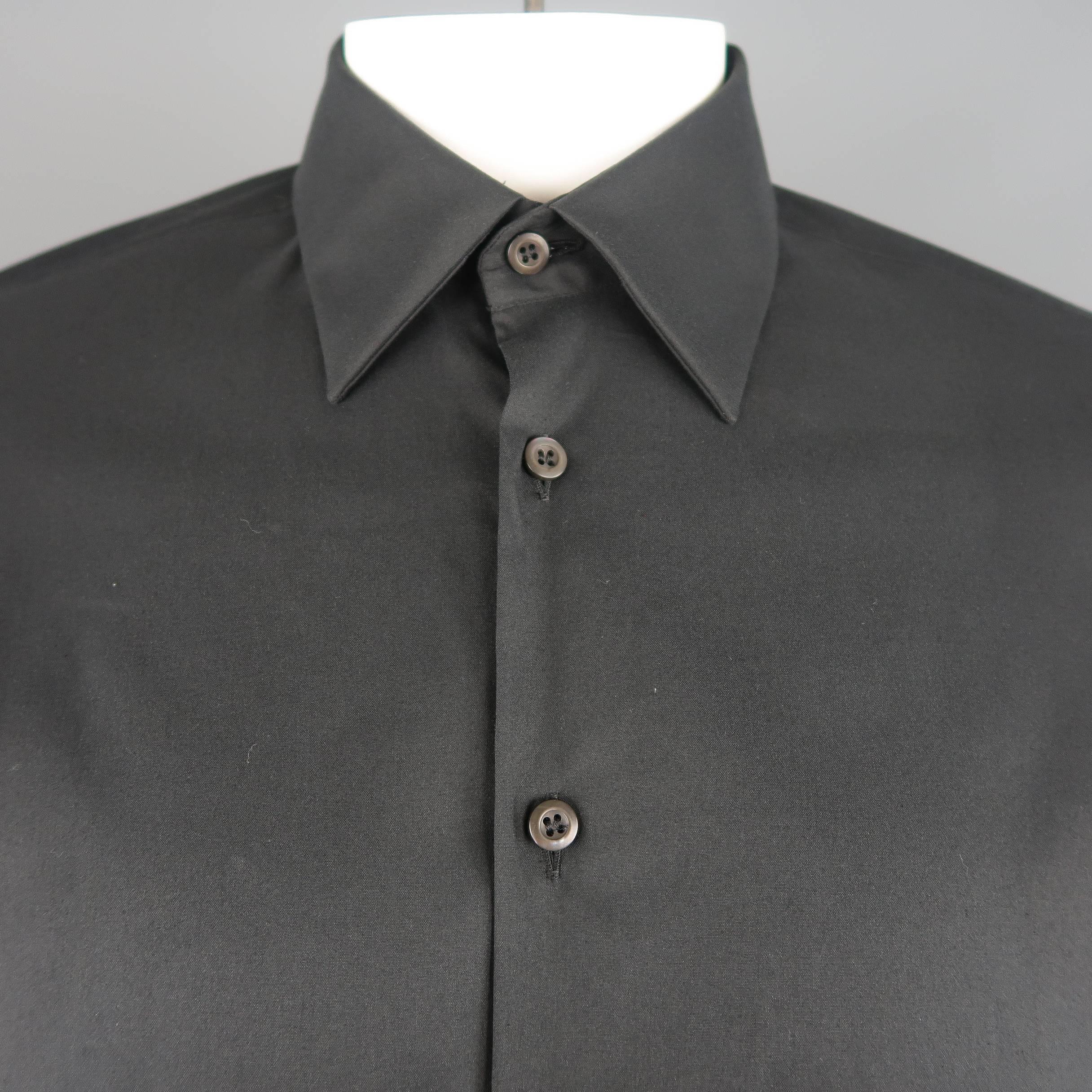 PRADA dress shirt comes in black stretch cotton with a pointed collar and slim fit. Made in Italy.
 
New with Tags.
Marked: 41 / 16
 
Measurements:
 
Shoulder: 18 in.
Chest: 44 in.
Sleeve: 27 in.
Length: 31 in.