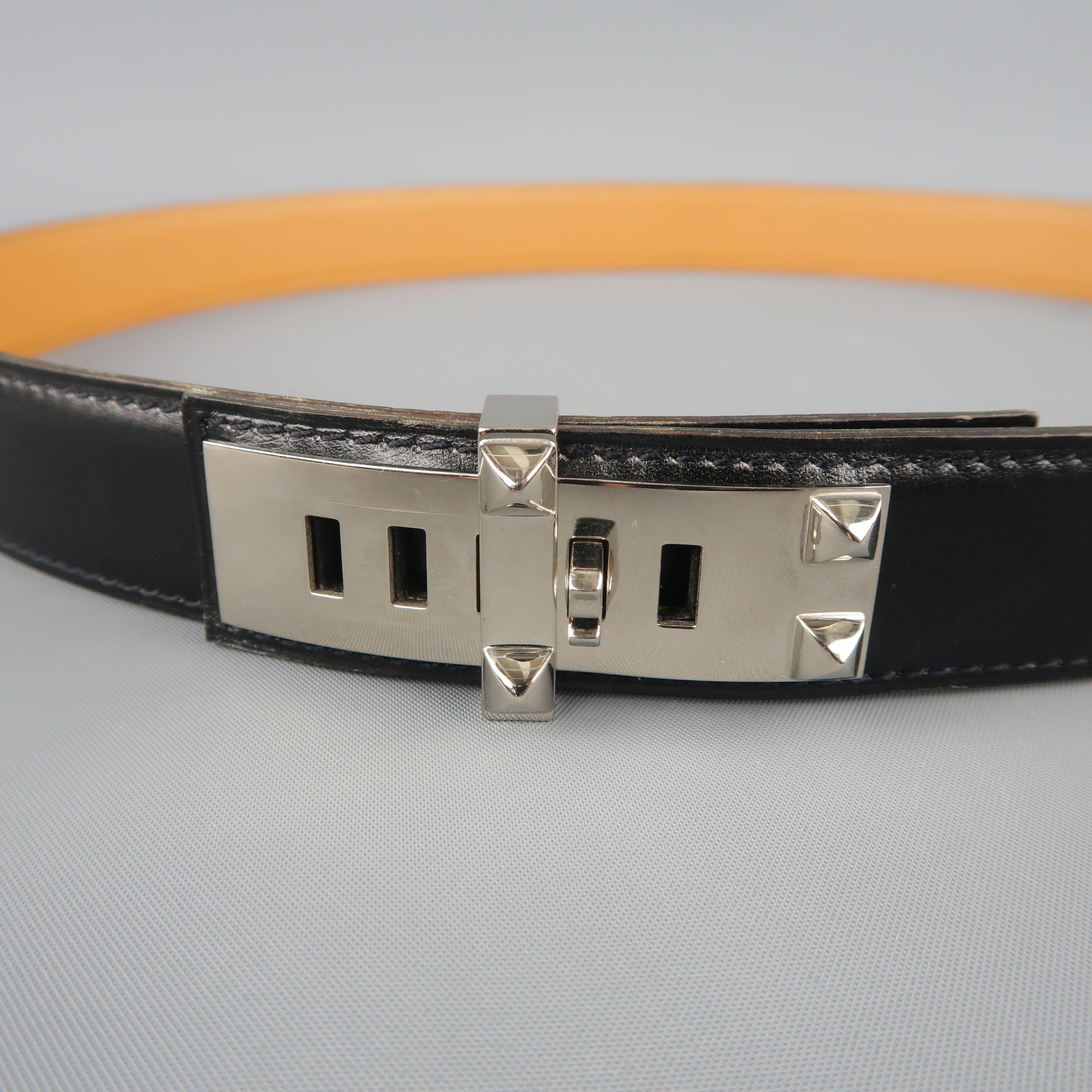 HERMES Collier de Chien Belt  comes in smooth black leather with tan leather liner and polished silver tone metal studded detail hardware. Very minor wear. With dust bag. Made in France.
 
Good Pre-Owned Condition.
Marked: 90
 
Length: 38.25