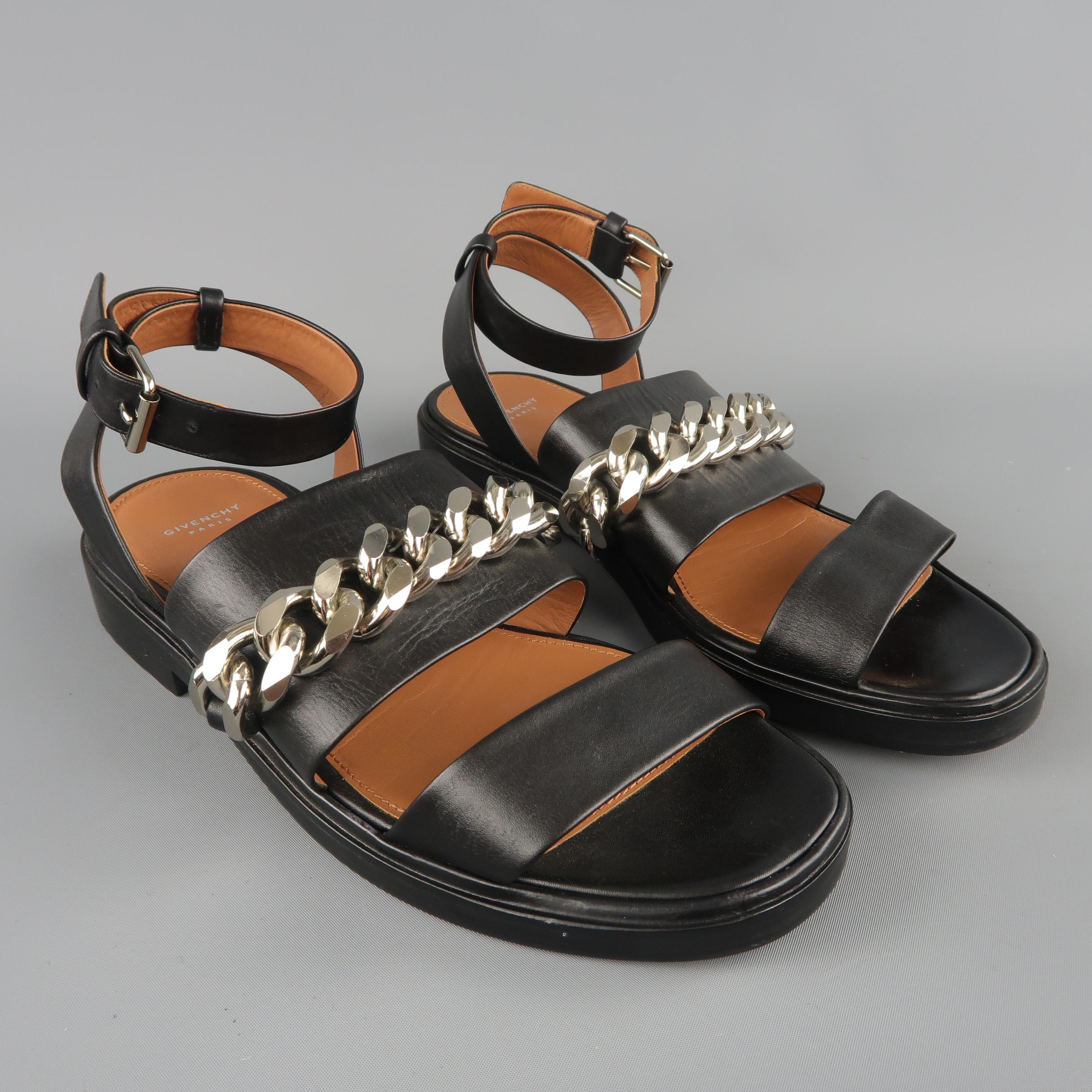 GIVENCHY by RICCARDO TISCI sandals feature two thick black leather straps with an oversized silver tone curb chain embellishment and wrapped ankle strap. With box. Made in Italy.
Excellent Pre-Owned Condition.
Marked: IT 38
 
Outsole: 10 x 4 in.