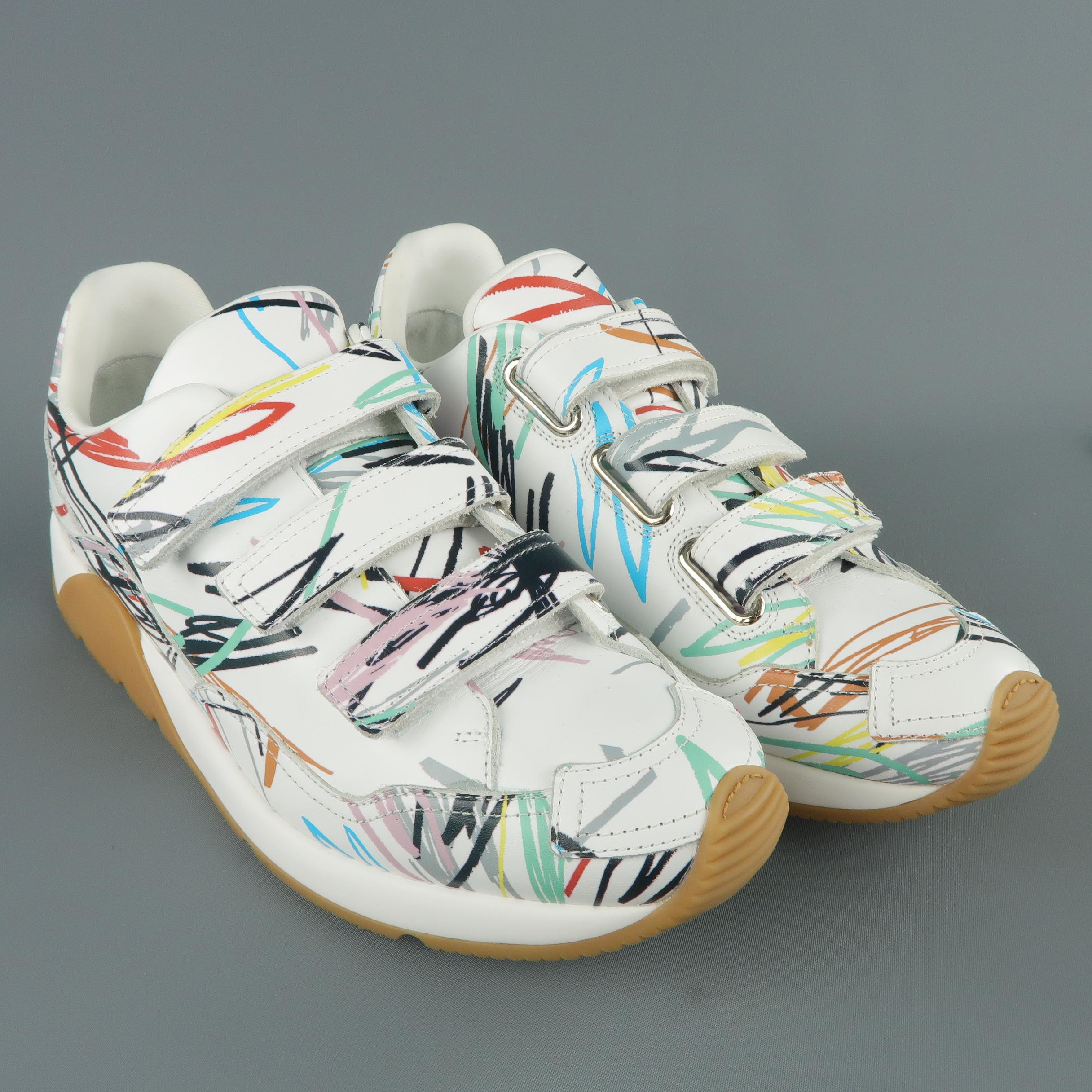 DIOR HOMME Spring-Summer 2015 runway sneakers come in white leather with multi-color scribble print throughout, triple velcro closure, thick rubber sole, and CD logo back.
 
Marked: IT 43
 
Outsole: 12.25 x 445 in.