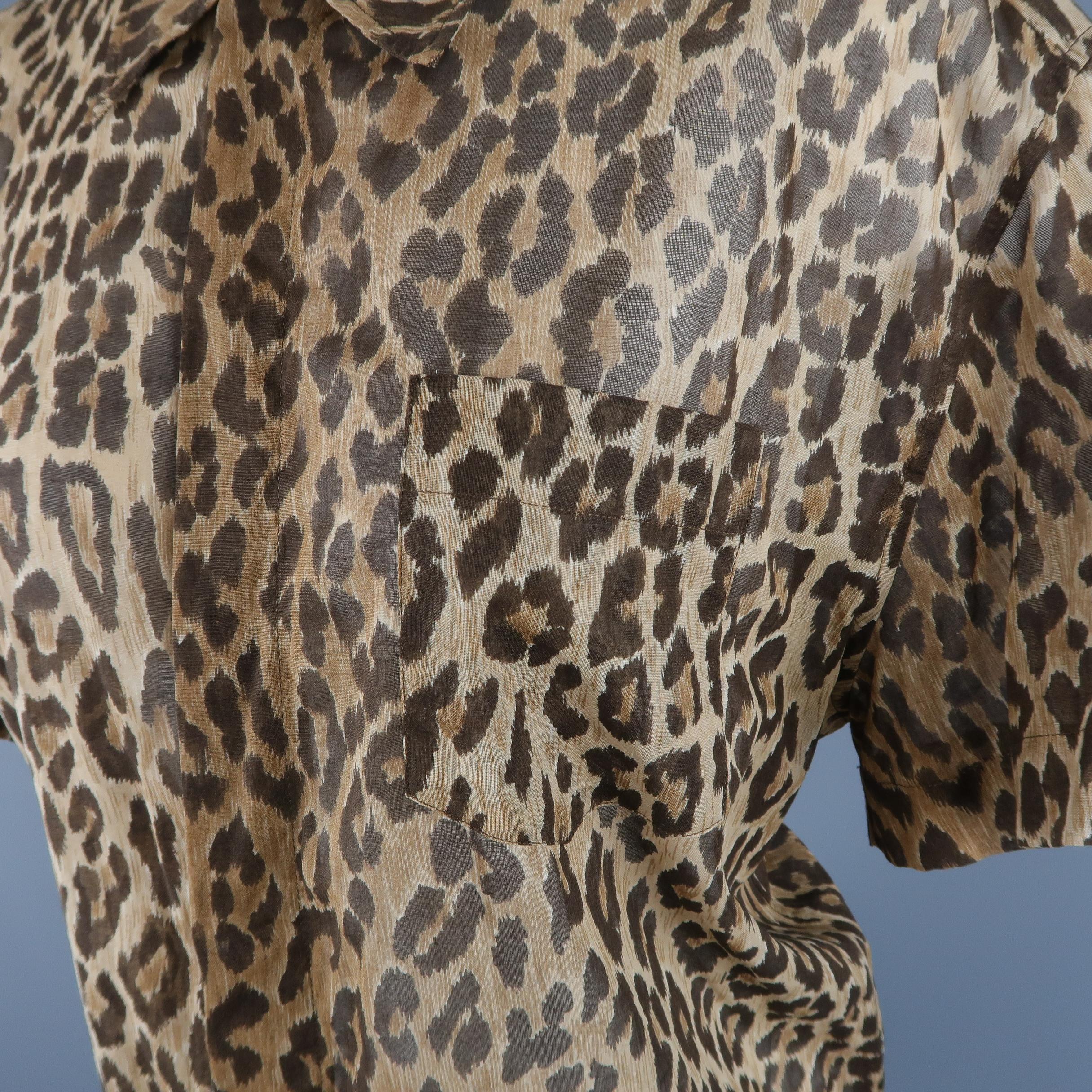 DOLCE & GABBANA blouse comes in sheer leopard print cotton with a pointed collar, short sleeves, breast pocket, and hidden snap front. Made in Italy.
 
Good Pre-Owned Condition.
Marked: IT 46
 
Measurements:
 
Shoulder: 18 in.
Bust: 44 in.
Sleeve: 8