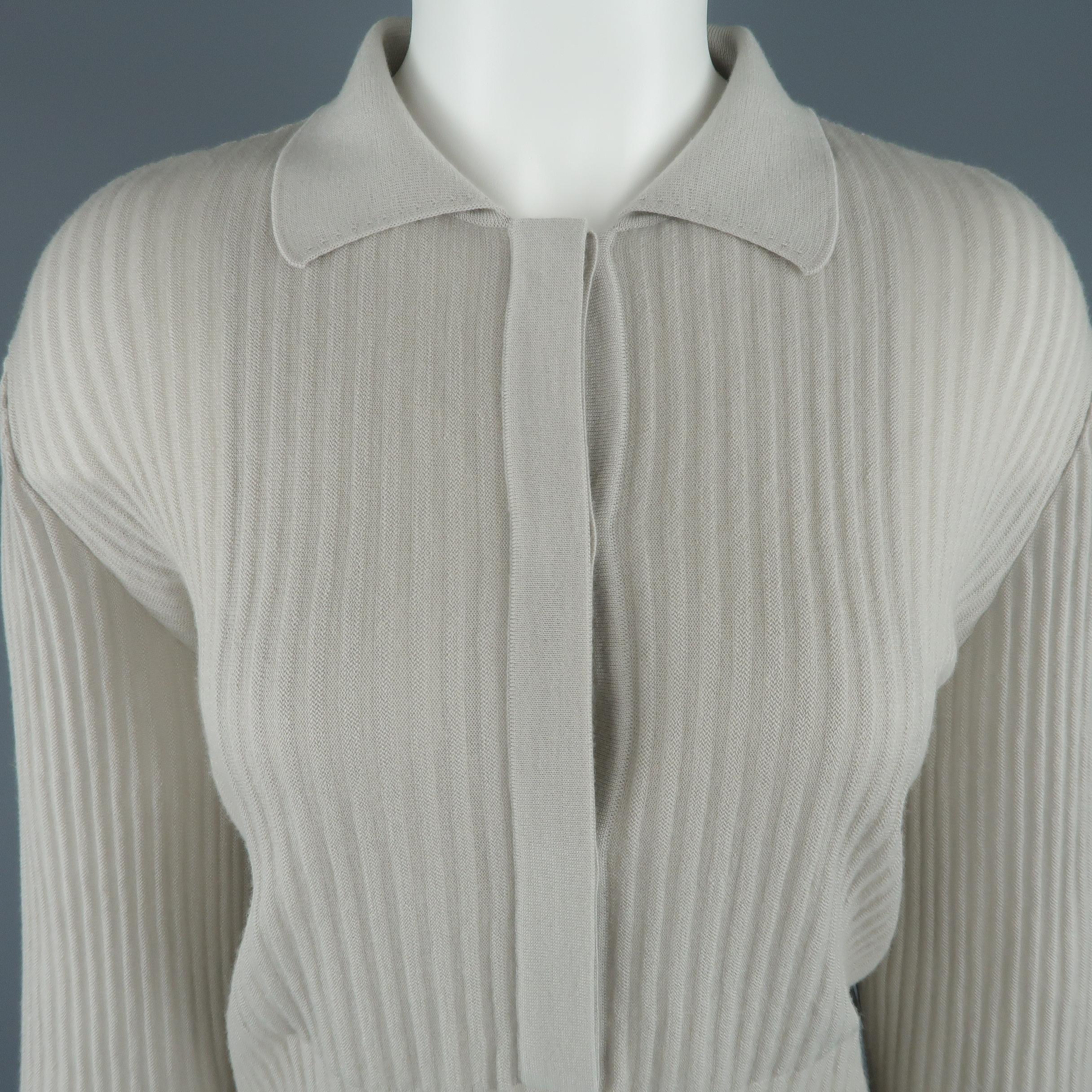 GIORGIO ARMANI pullover comes in sheer ribbed cashmere knit with a half button collared front. Made in Italy.
 
Excellent Pre-Owned Condition.
Marked: IT 46
 
Measurements:
 
Shoulder: 16 in.
Bust: 40 in.
Sleeve: 24 in.
Length: 26 in.
