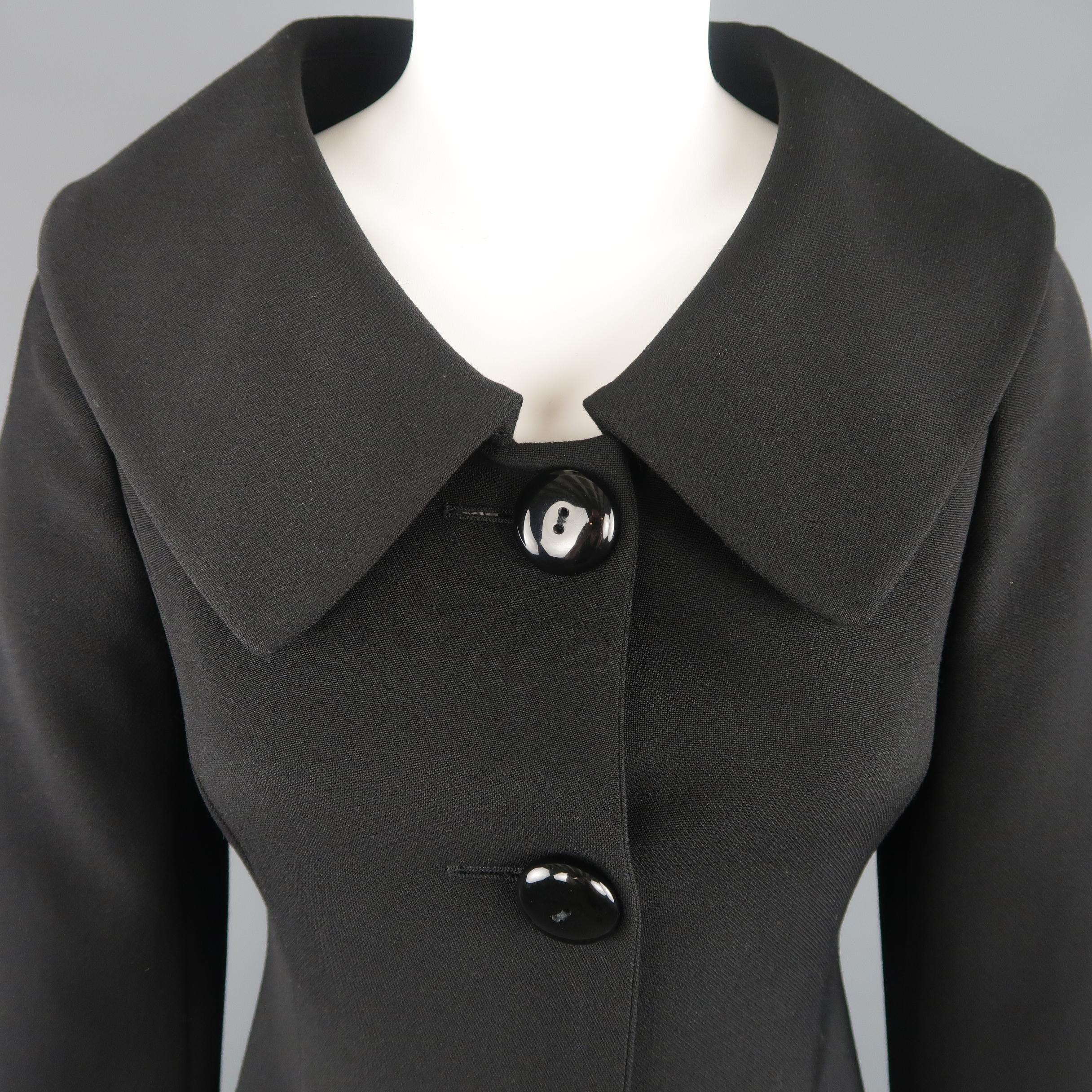 MOSCHINO CHEAP & CHIC coat comes in black wool blend fabric with an oversized scoop neck collar, slit pockets, and bow back detail. Made in Italy.
 
Excellent Pre-Owned Condition.
Marked: US 4
 
Measurements:
 
Shoulder: 14 in.
Bust: 34 in.
Waist: