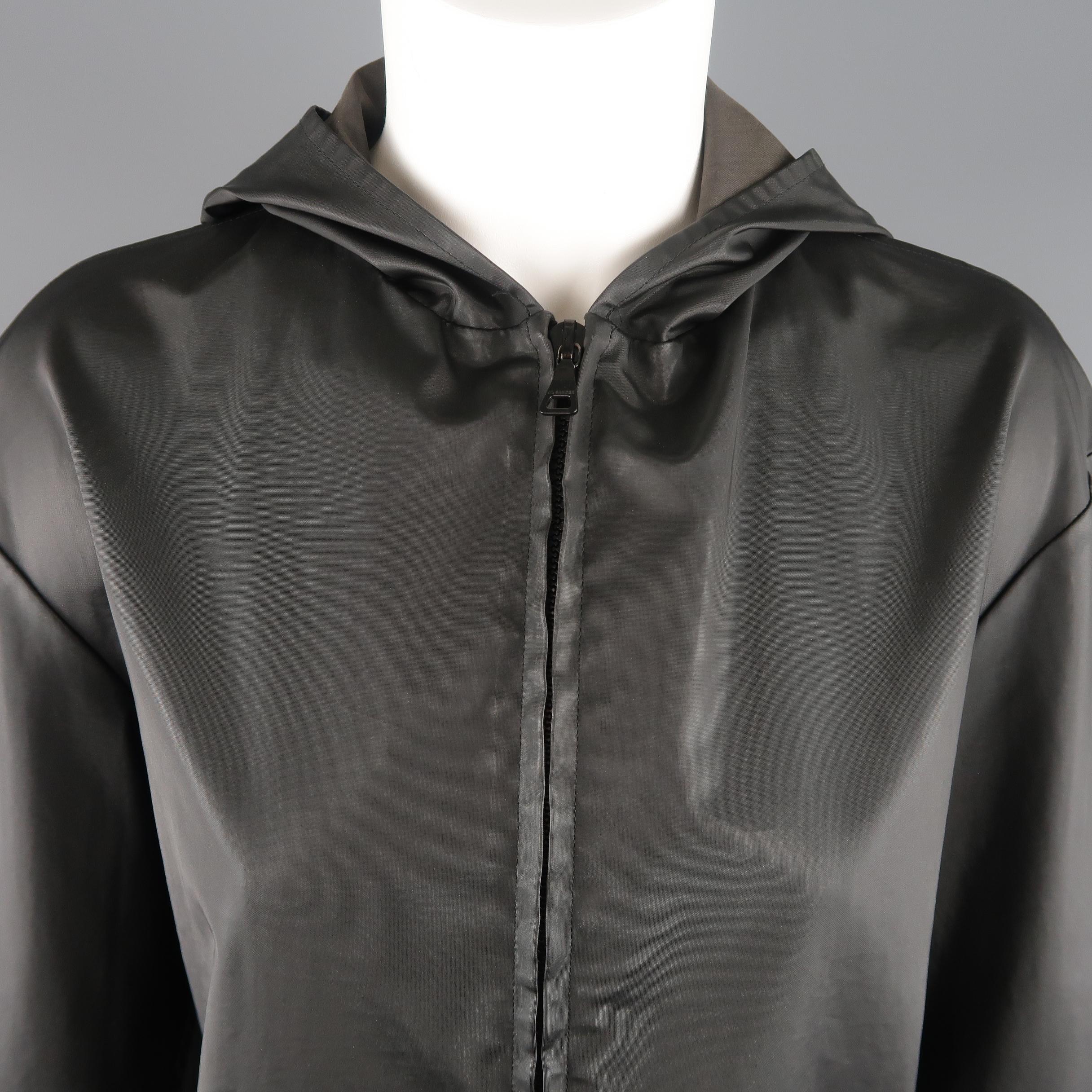 JIL SANDER hoodie comes in coated cotton canvas with a satin sheen featuring a double zip front, boxy silhouette, and slit pockets. Made in Italy.
 
Good Pre-Owned Condition.
Marked: IT 38
 
Measurements:
 
Shoulder: 19 in.
Bust: 42 in.
Sleeve: 22
