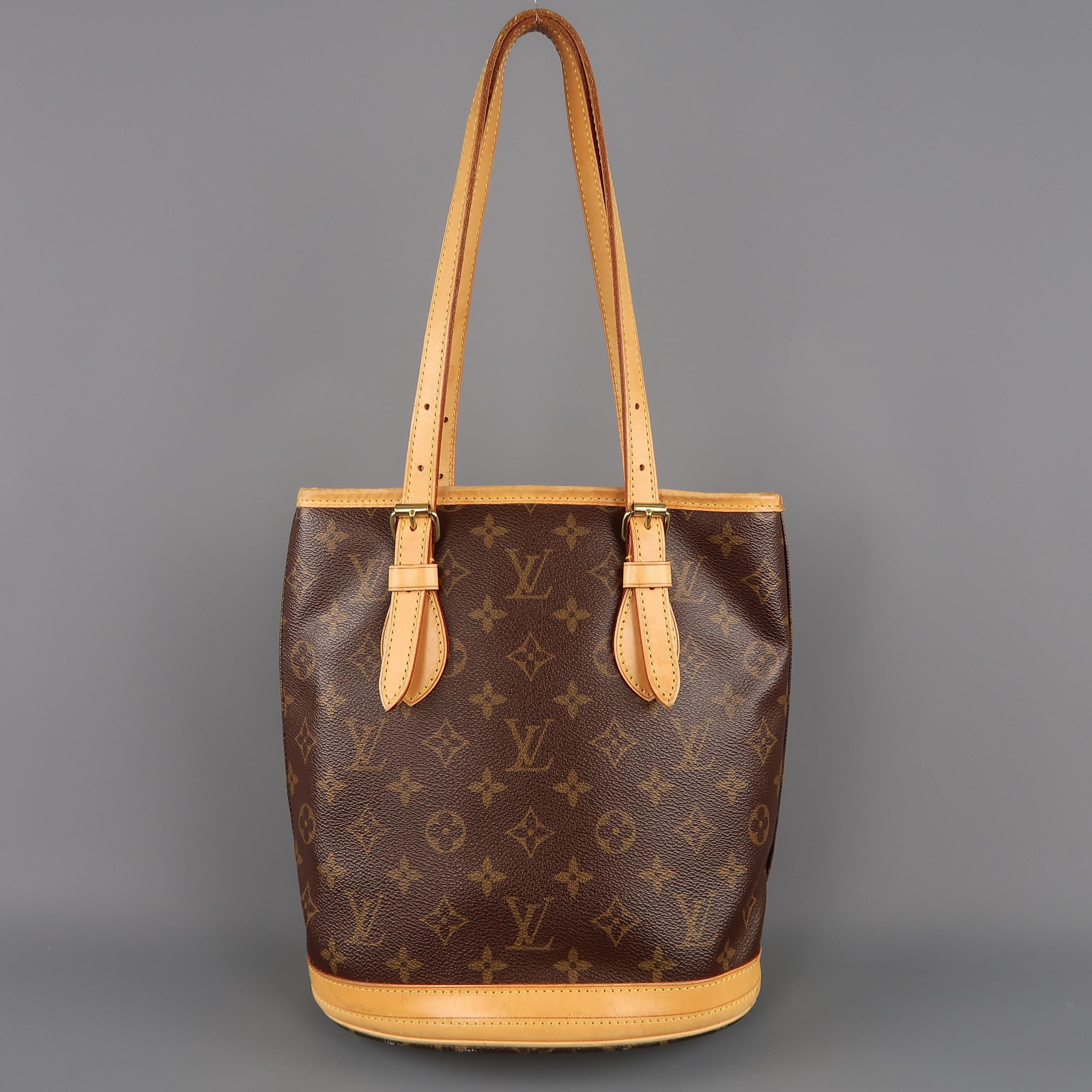 Vintage LOUIS VUITTON Bucket PM bag comes in classic brown monogram coated canvas with Vachetta leather trim and double top handles. Wear throughout and petina on leather. As-is. Made in USA.
 
Fair Pre-Owned Condition.
 
Measurements:
 
Length:
