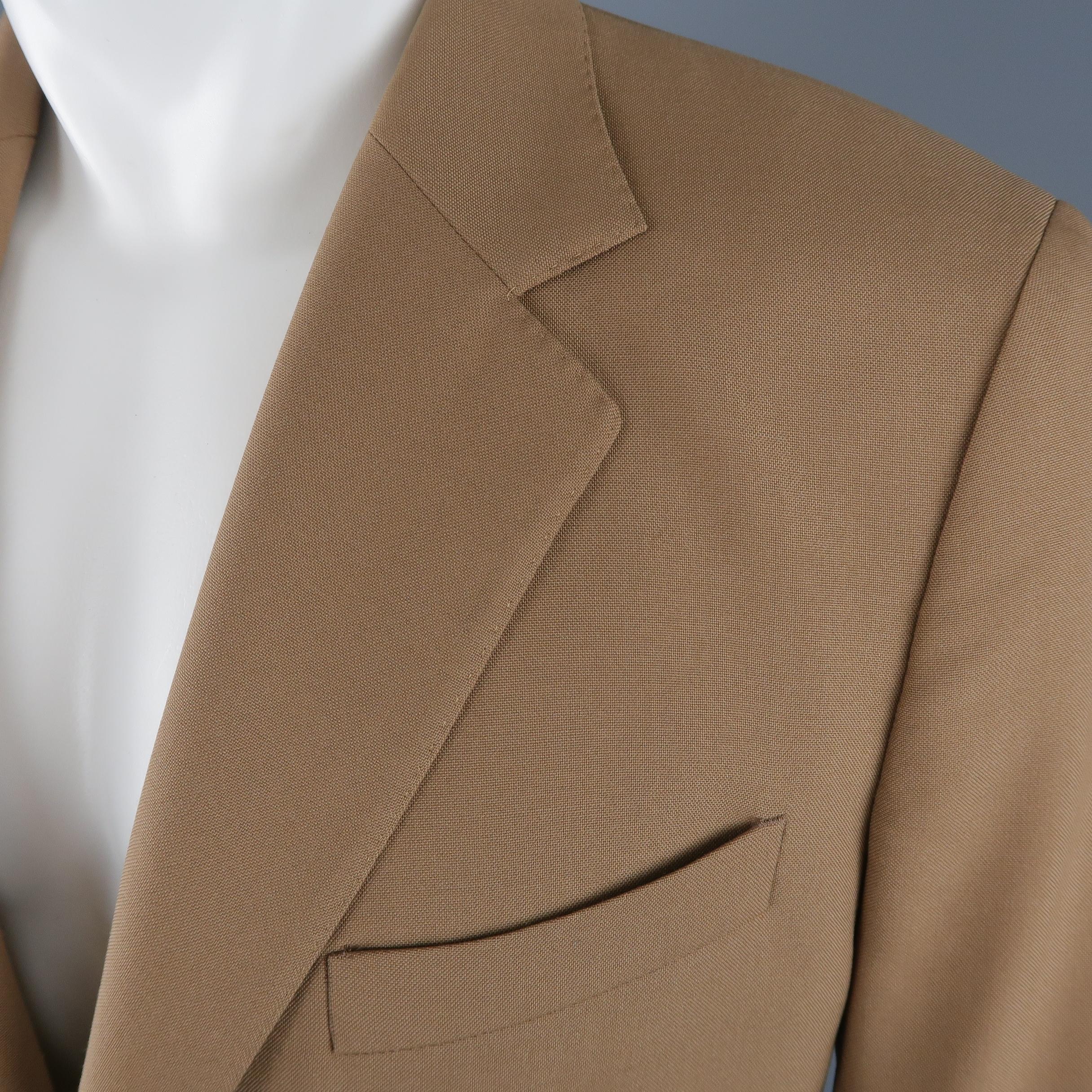 Single breasted BALENCIAGA sport coat comes in a wool blend woven canvas material with a notch lapel, two button front, functional button cuffs, and top stitching throughout. Stain at hem. As-is.  Made in Italy.
 
Fair Pre-Owned Condition.
Marked: