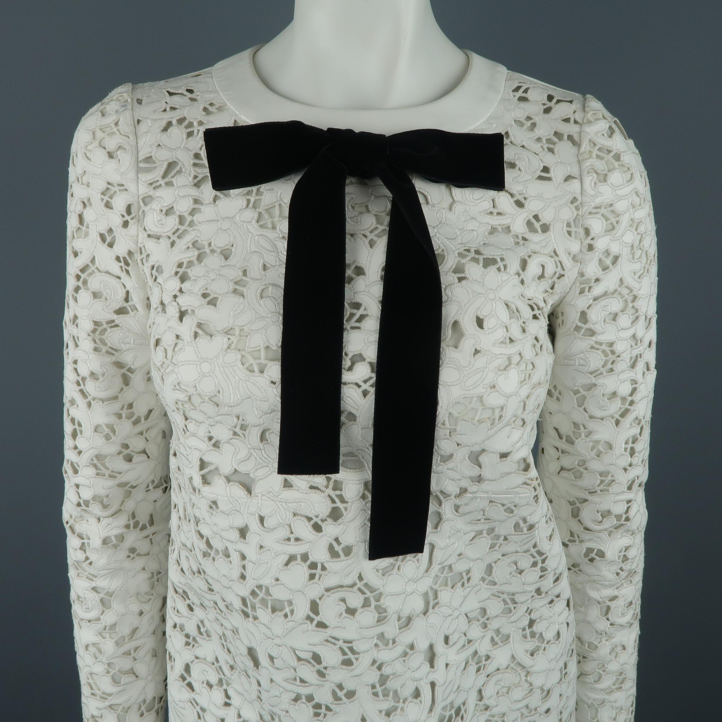 TOM FORD shift dress comes in white leather embroidered and laser cut into floral lace with a round neckline adorned with a black velvet bow and silk chiffon liner. Spots shown in detail shots. As-is. Worn once.  Made in Italy.
 
Good Pre-Owned