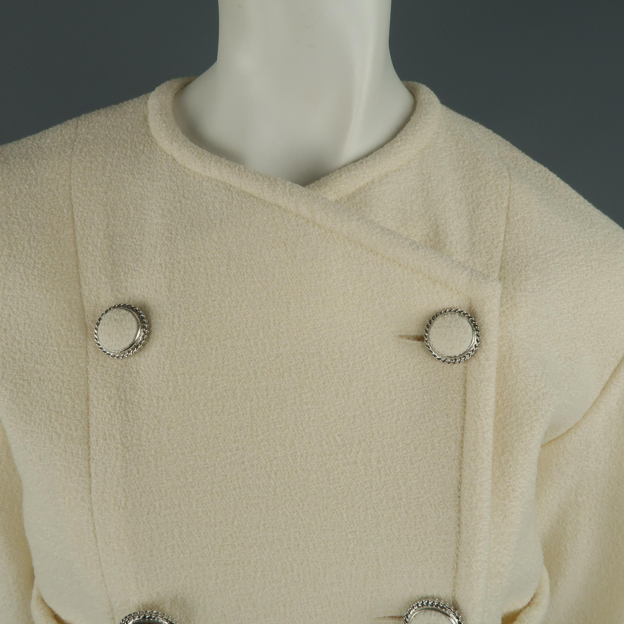 Chanel jacket comes in ivory cream wool tweed with a double breasted front, silver tone metal fabric buttons, cropped sleeves and length, and patch pockets. Matching pants available separately. Made in France.
 
Excellent Pre-Owned