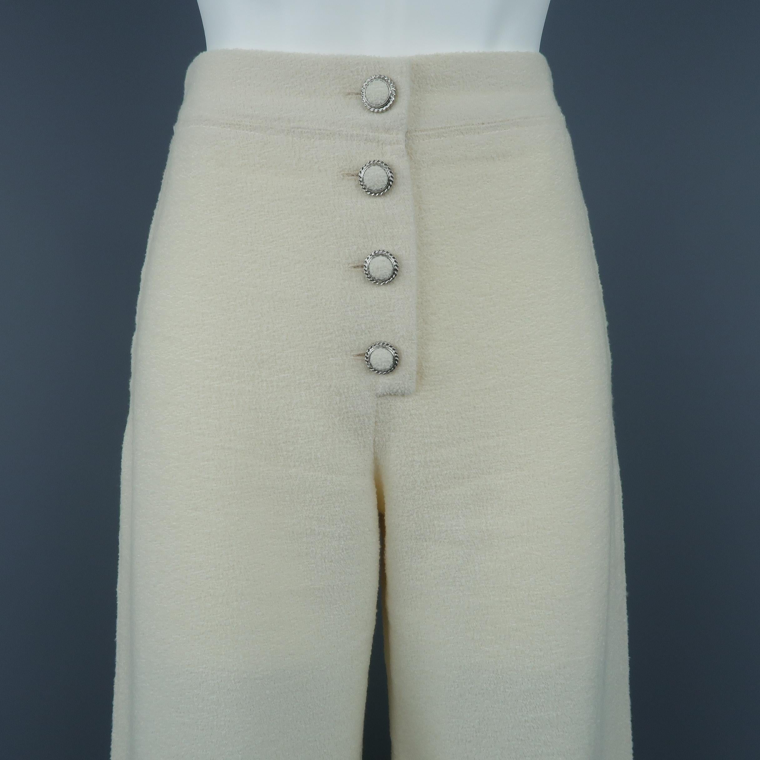 Chanel dress pants come in ivory cream wool tweed with a high rise, silver tone metal and fabric button fly, and wide leg. Matching cropped jacket available separately. Made in France.
 
Excellent Pre-Owned Condition.
Marked: FR 34
 
Measurements:
