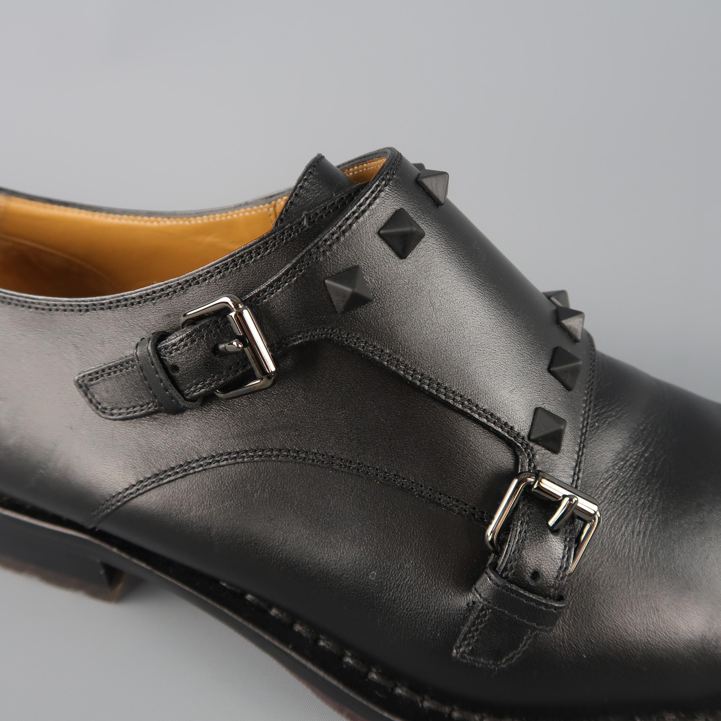 VALENTINO dress shoes come in smooth black leather with a double monk strap, black rubberized Rock Studs, and commando style sole. Worn once back stud damaged. As-is. Made in Italy.
 
Good Pre-Owned Condition.
Marked: IT 44
 
Outsole: 12.25 x 4.5 in.