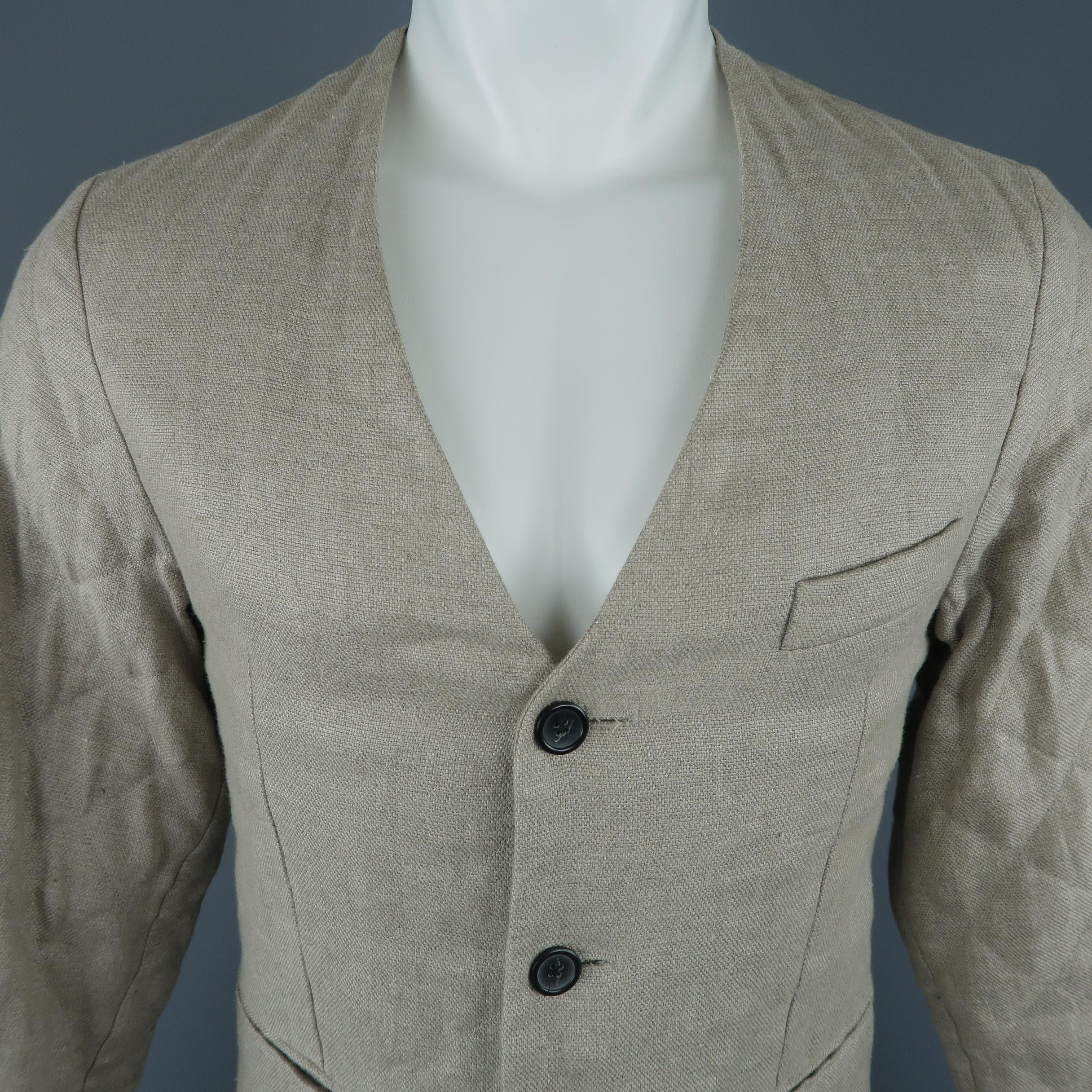 RAF SIMONS Spring Summer 2009 Collection sport coat jacket comes in a khaki beige quilted linen material with a collarless V neck, three button front, and simulated slit pockets. Altered to fit a slim silhouette and minor wear. As-is.
 
Good