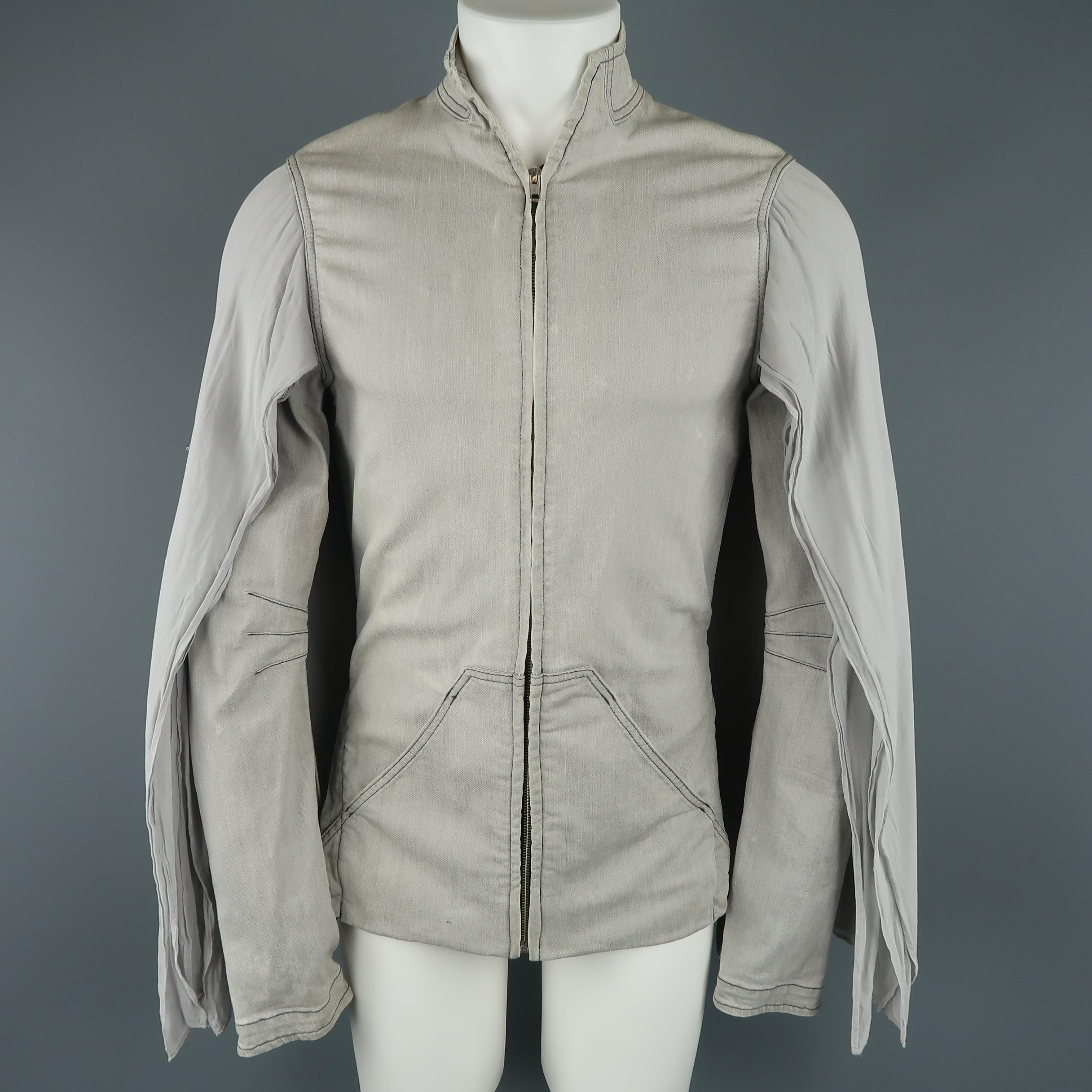 GARETH PUGH jacket comes in light gray washed denim with a high collar, zip front, pouch pockets, fitted sleeves with bondage strap, and layered cape overlay. Wear and discolorations throughout. As-is.Made in Italy.
 
Fair Pre-Owned