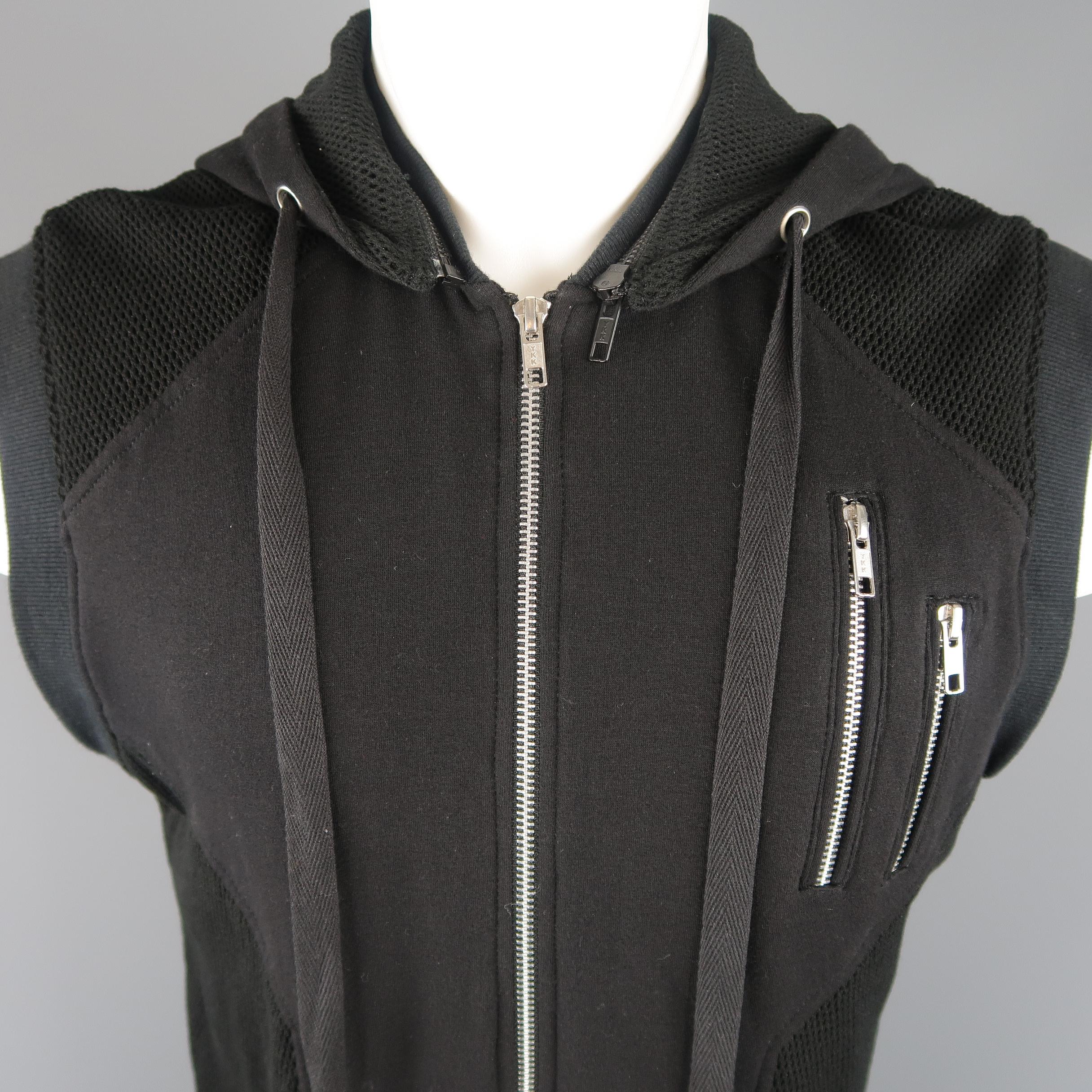 SKINGRAFT vest comes in black cotton jersey with mesh panels, zip pockets, layered effect, and zip off hood. Wear throughout.
 
Good Pre-Owned Condition.
Marked: S
 
Measurements:
 
Shoulder: 16 in.
Chest: 42 in.
Length: 24-32 in.