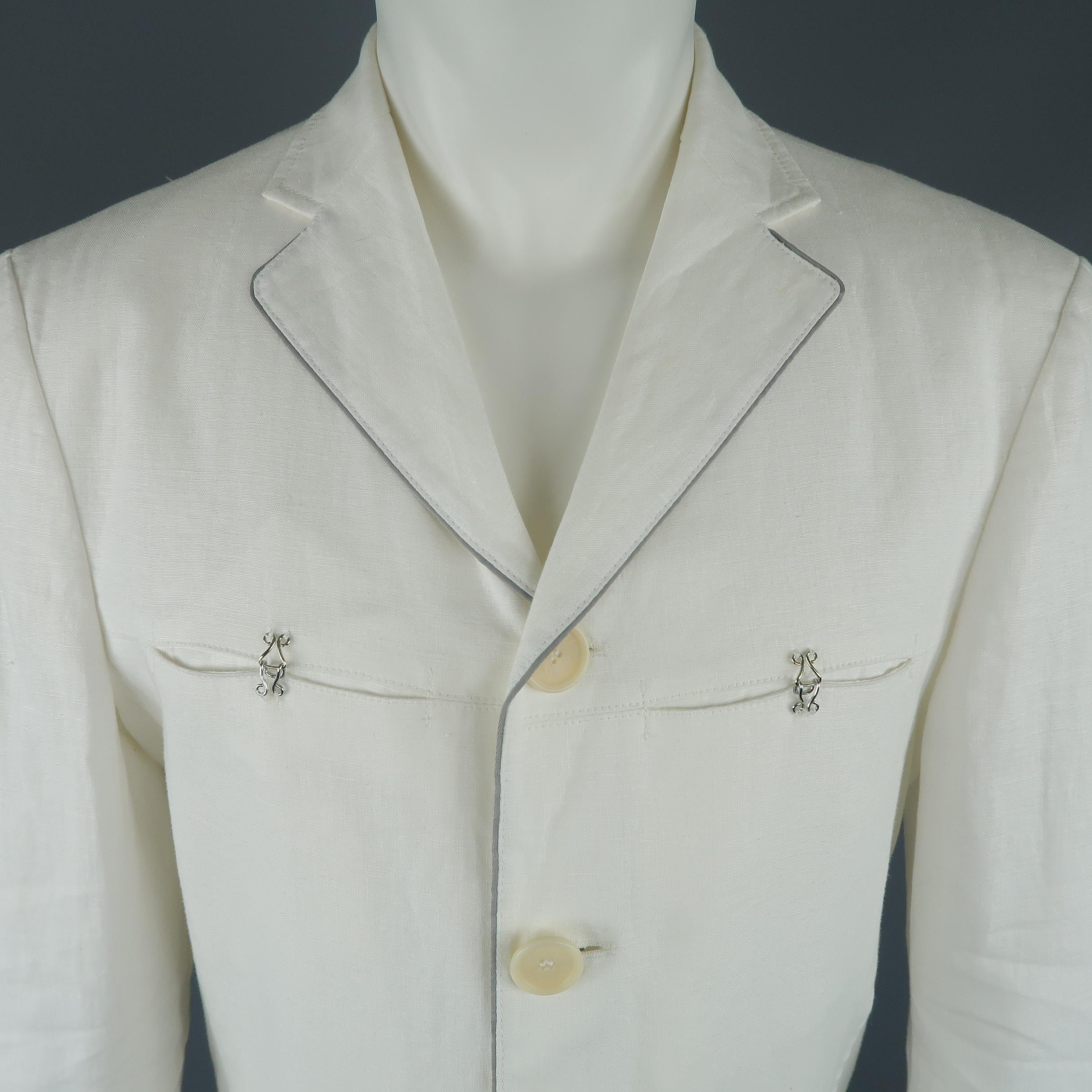 Vintage JEAN'S PAUL GAULTIER sport coat comes in white linen with a notch lapel, four button front, hook eye chest pockets, pleated patch flap pockets, and gray piping. Minor wear. Made in Italy.
 
Good Pre-Owned Condition.
Marked: IT 50
