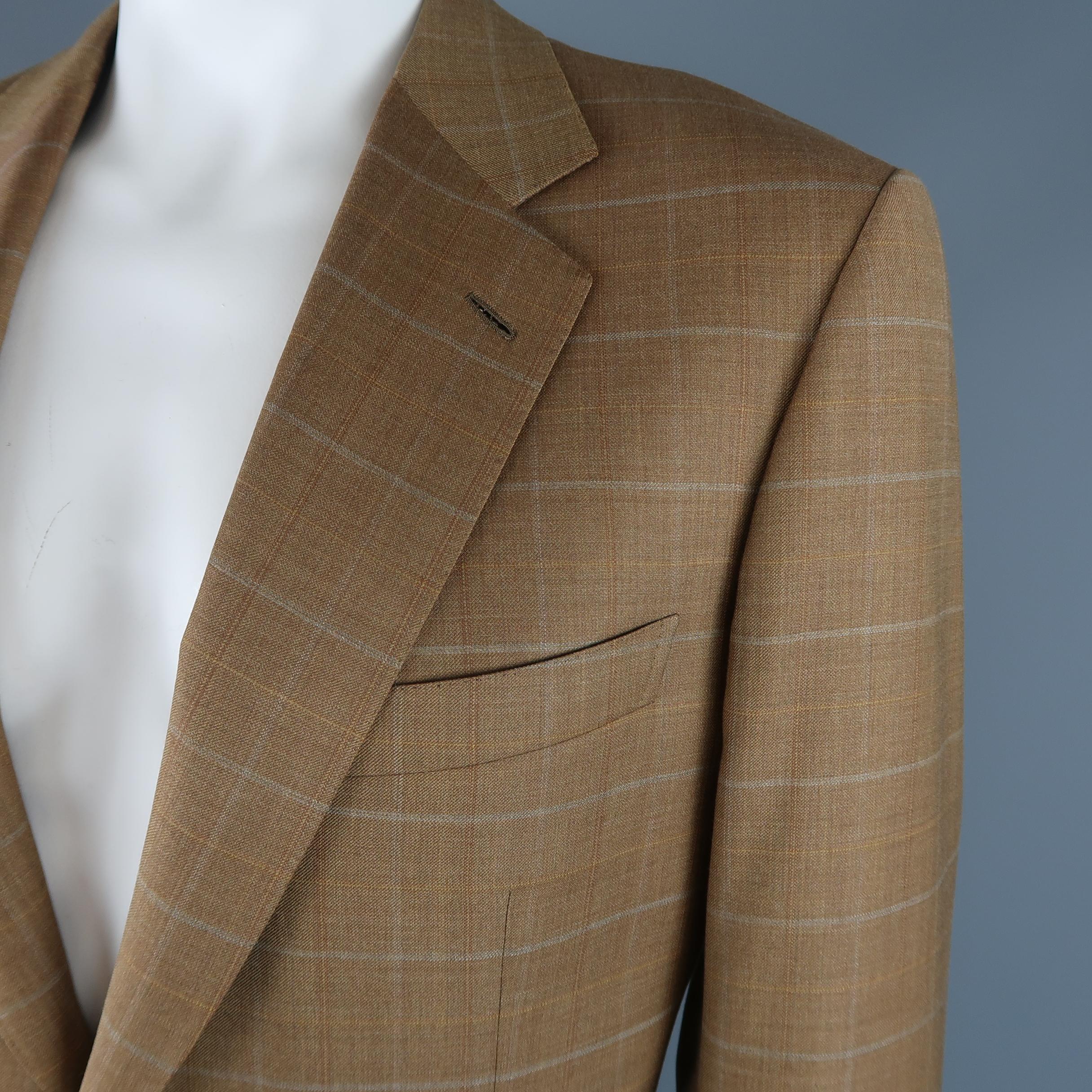 Vintage BRIONI single breasted sport coat comes in golden tan wool with all over window pane pattern and features a wide notch lapel, two button front, flap pockets, and satin liner. Made in Italy.
 
Excellent Pre-Owned Condition.
Marked: 44
