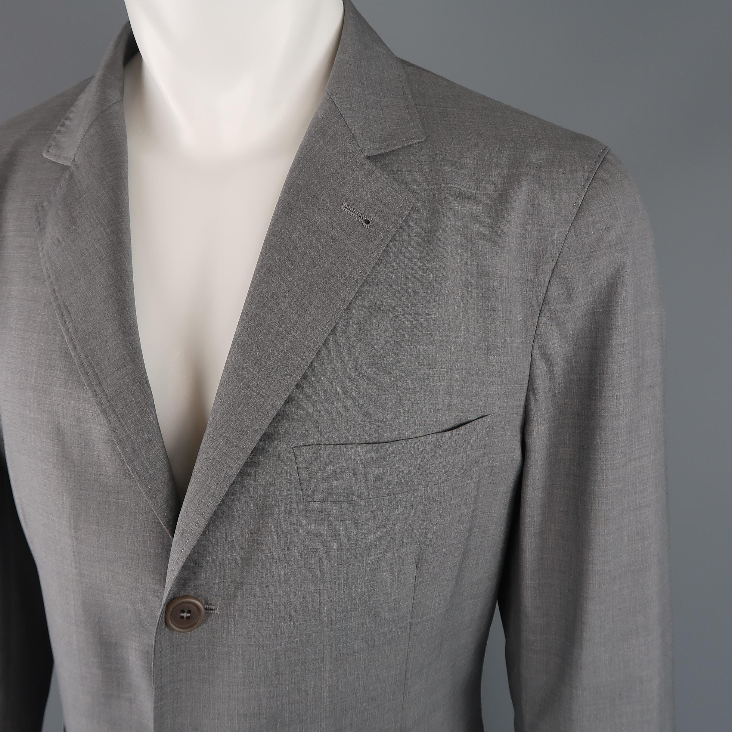 BRUNELLO CUCINELLI single breasted sport coat comes in a light weight wool silk blend fabric with a notch lapel, three button front, triple pockets and half liner. Stain and broken button on cuff. As-is. Made in Italy.

Retail: $2500.00 
Good