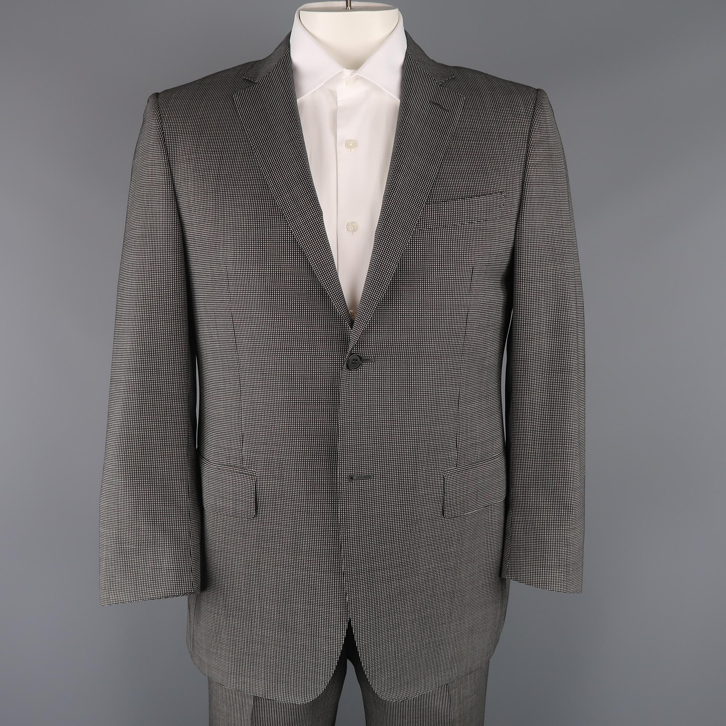 Two piece CANALI suit come sin black and white Nailhead pattern wool and includes a single breasted, two button sport coat with notch lapel, and matching flat front trousers. Made in Italy.
 
Excellent Pre-Owned Condition.
Marked: IT 52
