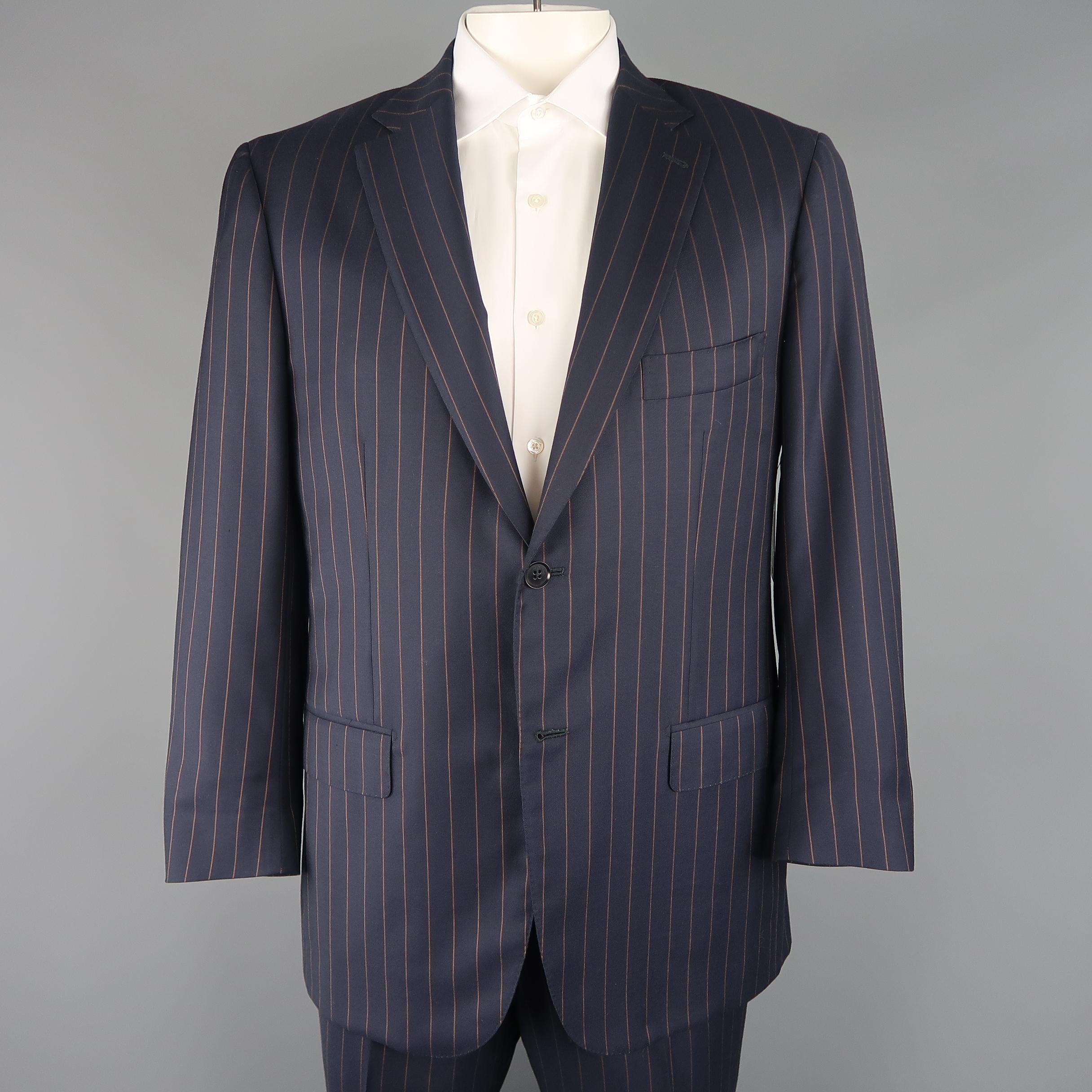 Two piece ISAIA suit comes in navy wool twill with a tan chalk strip throughout and includes a single breasted, two button sport coat with a notch lapel and matching flat front trousers.  Made in Italy.
 
Excellent Pre-Owned Condition.
Marked: IT