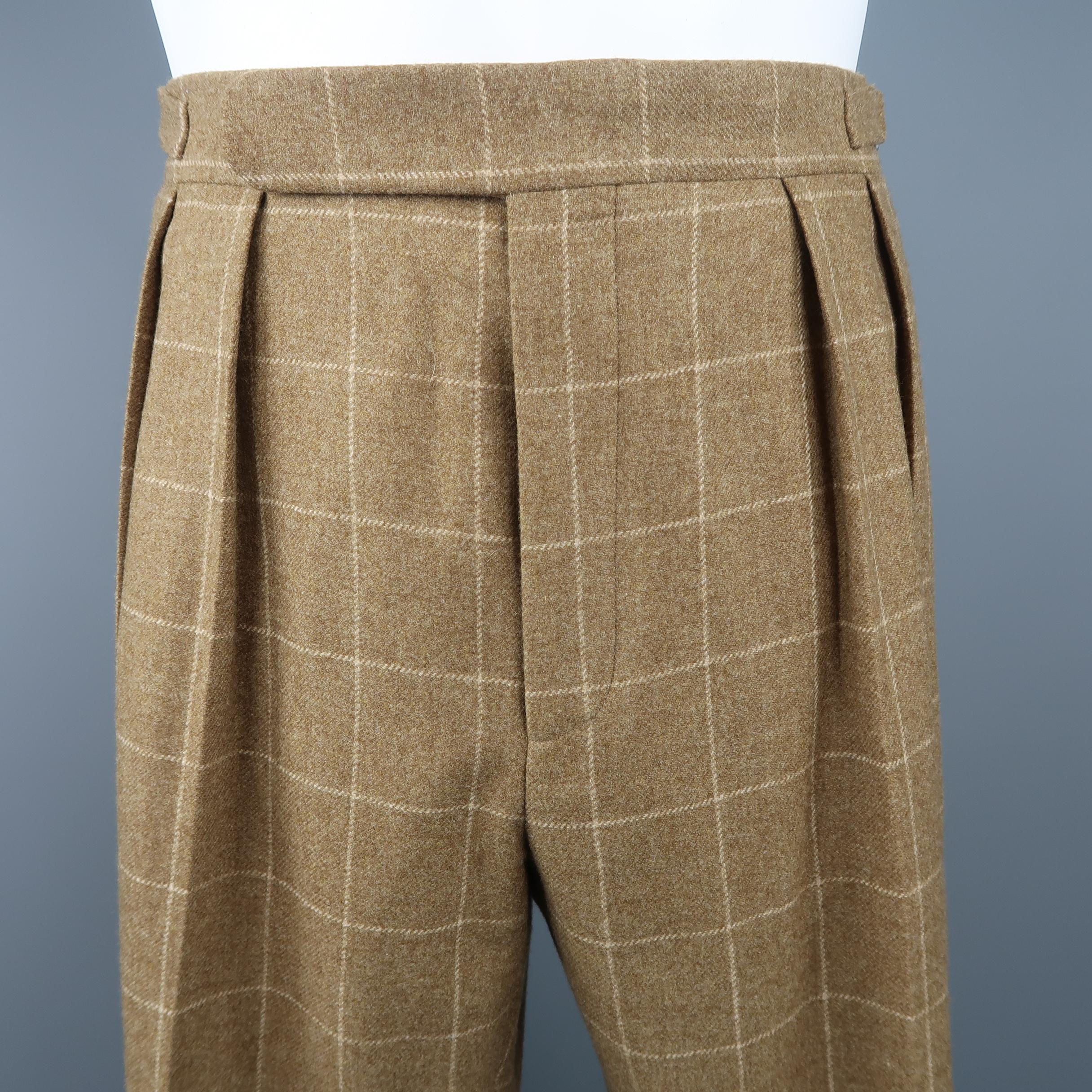 POLO RALPH LAUREN trousers come in tan windowpane wool with a pleated front, side tabs, and cuffed hem. Made in Italy.

Retai: $395
Good Pre-Owned Condition.
Marked: 34
 
Measurements:
 
Waist: 34 in.
Rise: 11.5 in.
Inseam: 30 in.