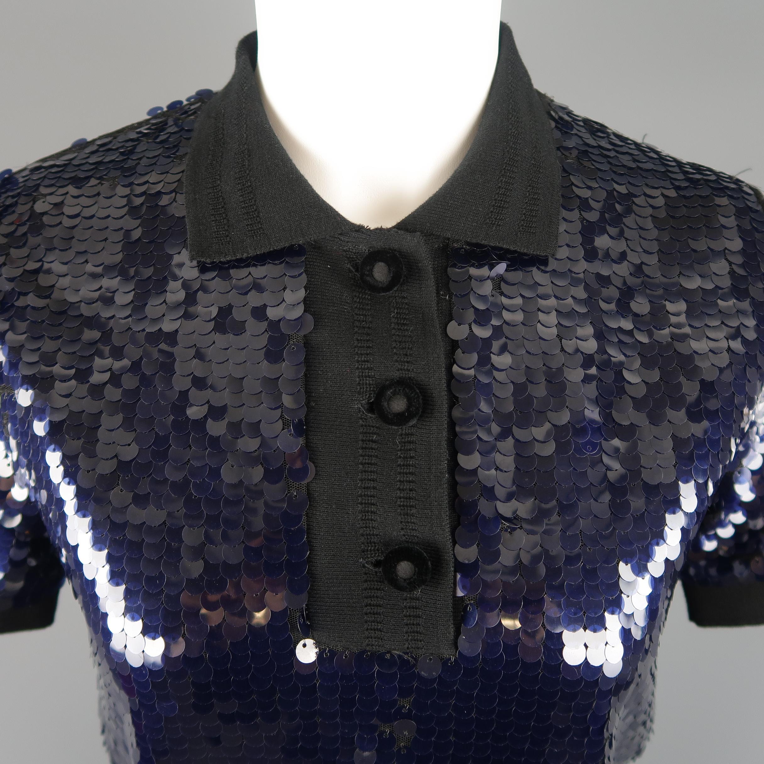 CARVEN polo style top comes in navy blue payette sequin fabric with black knit collar cuffs, and half button closure. Some wear through fabric. Fully lined. No stretch. Runs small.
 
Good Pre-Owned Condition.
Marked: M
 
Measurements:
 
Shoulder: