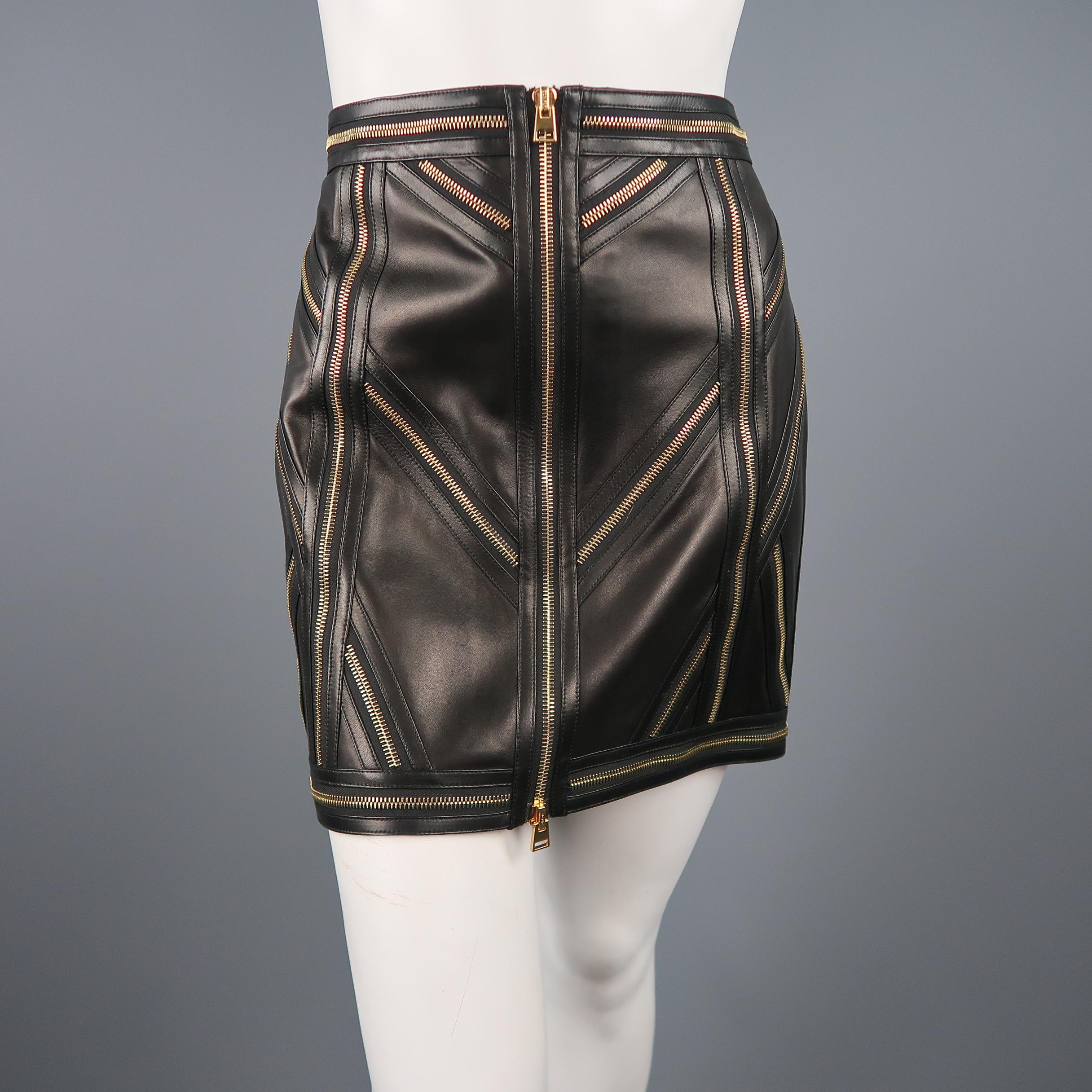 TOM FORD mini skirt comes in smooth black leather with a gold tone double zip frontal closure and directional patchwork zip panel pattern throughout. Made in Italy.
 
Excellent Pre-Owned Condition.
Marked: IT 42
 
Measurements:
 
Waist: 31 in.
Hip: