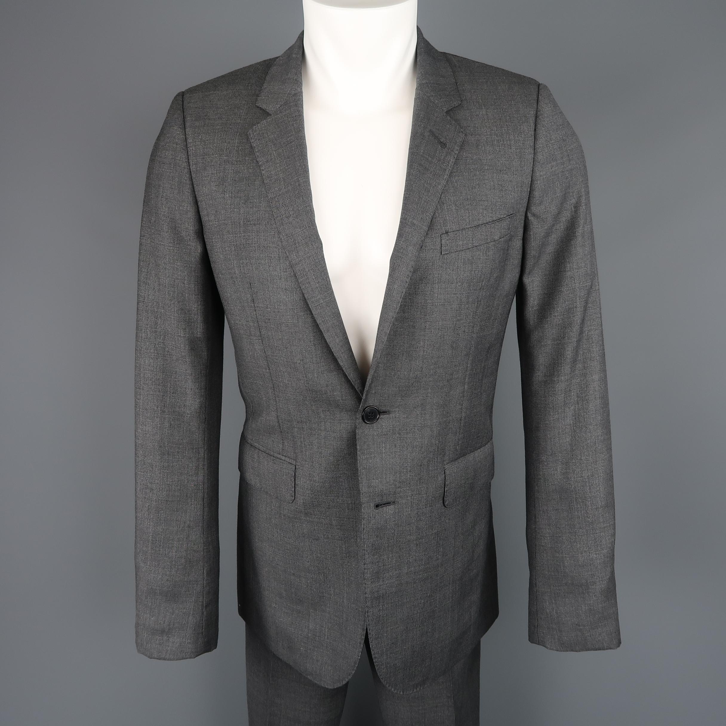 This SAINT LAURENT two piece slim fit suit comes in dark gray wool with a subtle plaid print and includes a single breasted, two button, notch lapel sport coat and matching flat front trousers. Made in Italy.
 
Excellent Pre-Owned Condition.
Marked: