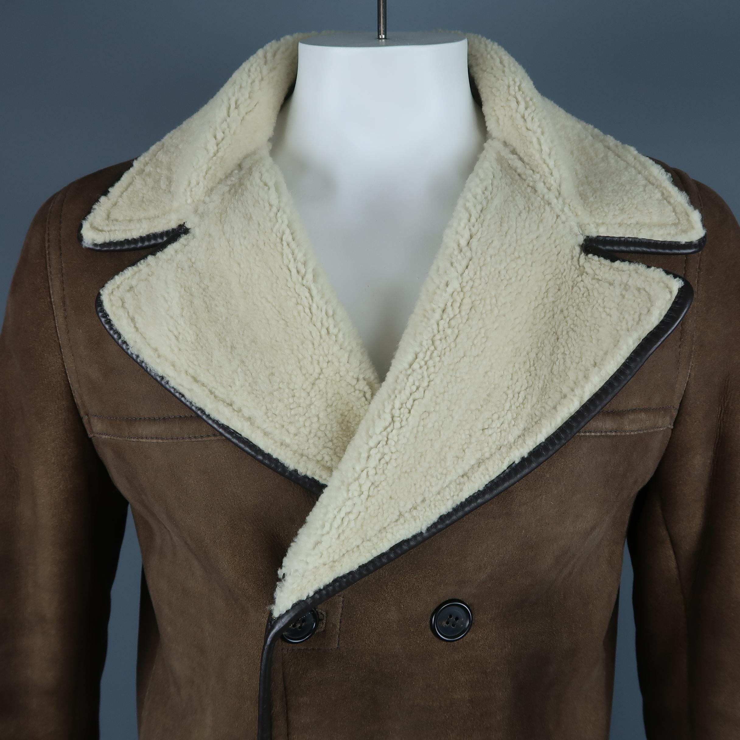 Double breasted PRADA coat comes in light brown shearling with cream fur liner, pointed lapel, and brown leather piping. Discolorations throughout. As-is. Made in Italy.
 
Fair Pre-Owned Condition.
Marked: IT 54
 
Measurements:
 
Shoulder: 18