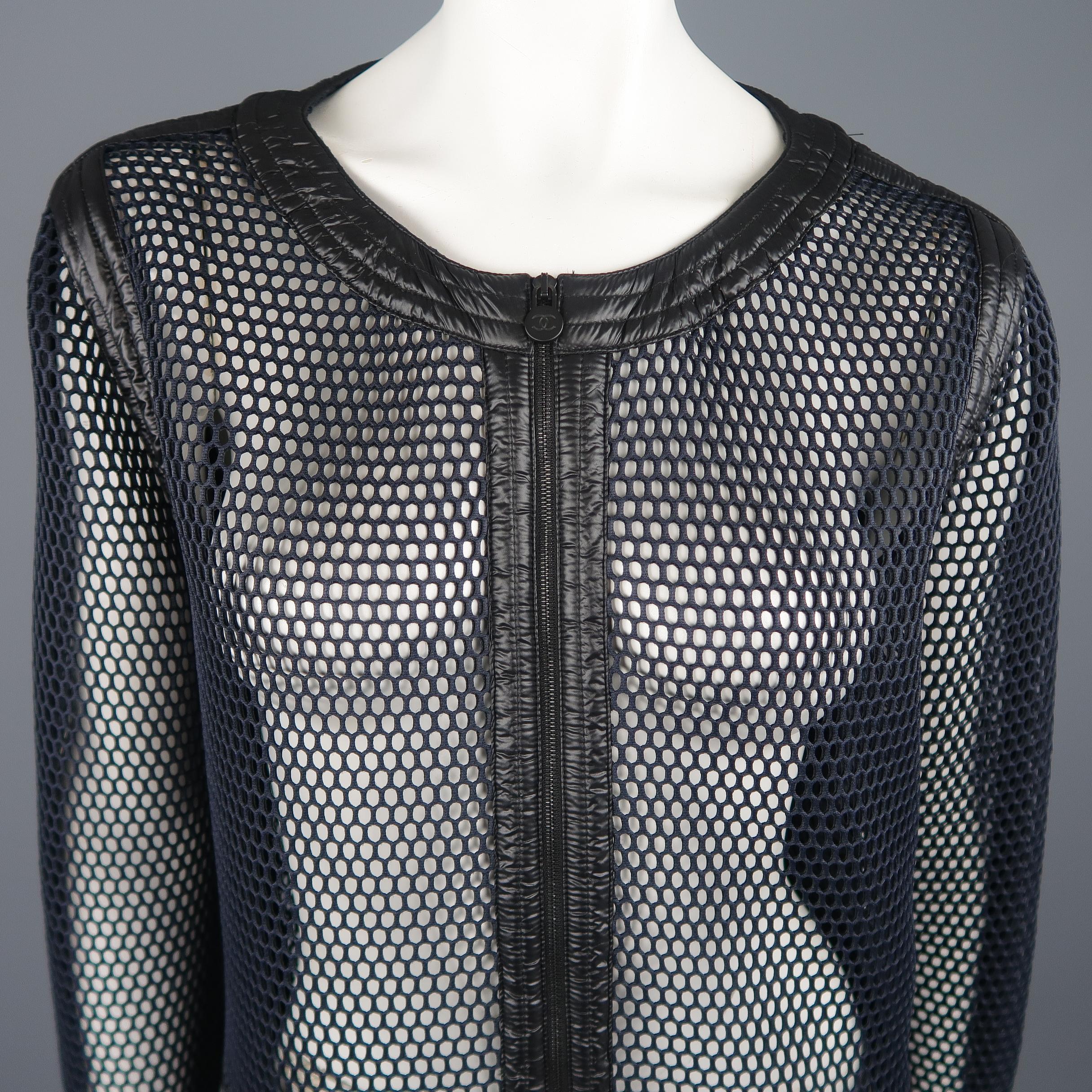 This sporty Chanel jacket comes in navy structured mesh with a round scoop neck, zip pockets, matte black metal CC tabs, and shiny quilted nylon trim. Made in Italy.
 
Excellent Pre-Owned Condition.
Marked: (no size)
 
Measurements:
 
Shoulder:17